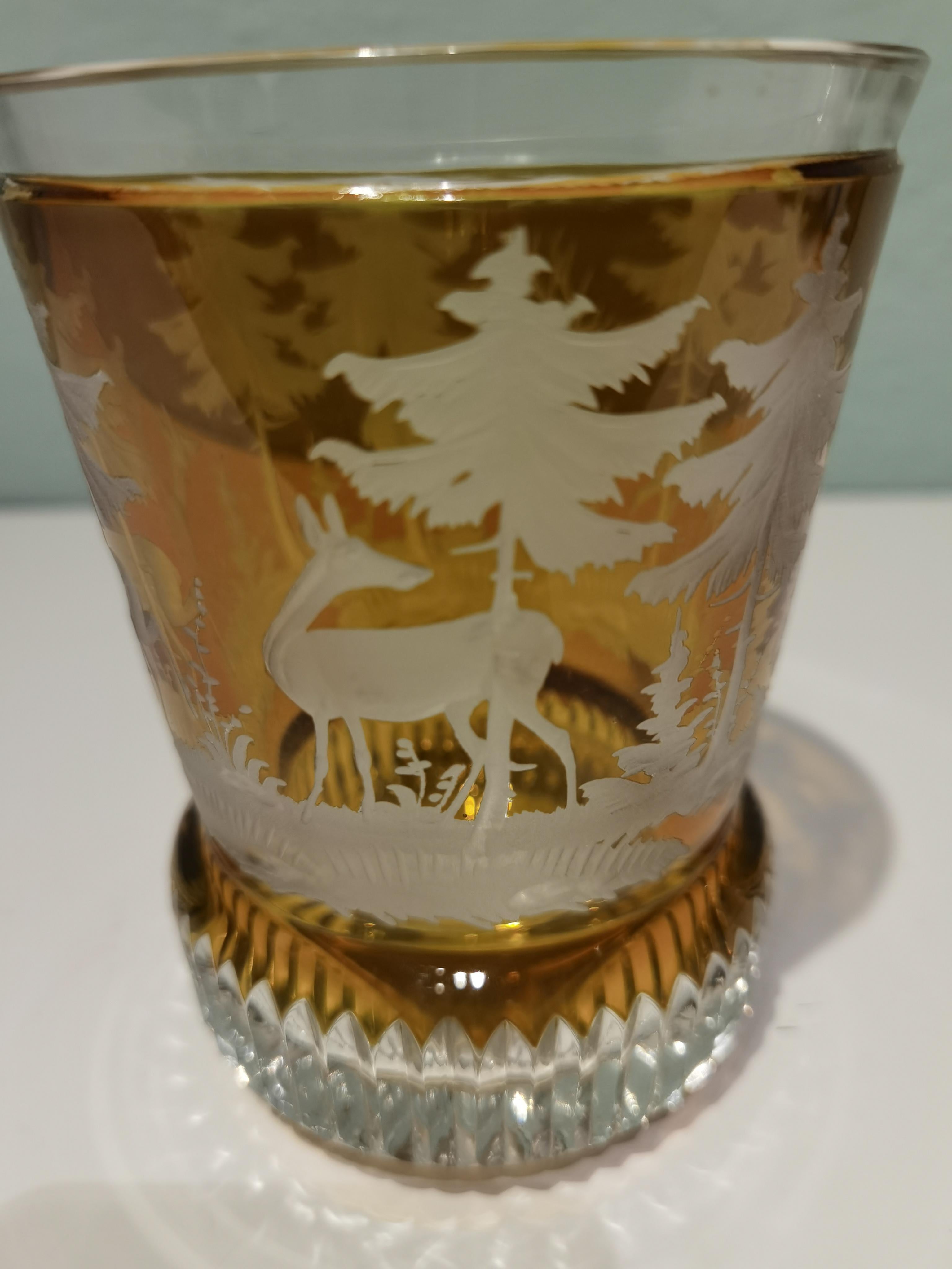 Hand blown crystal latern in amber glass from Bavaria. The votiv is hand blown and the decor is hands-free engraved by glass artists all around with a hunting scene with trees and deers in the style of Black Forest. Sofina glass and porcelain was