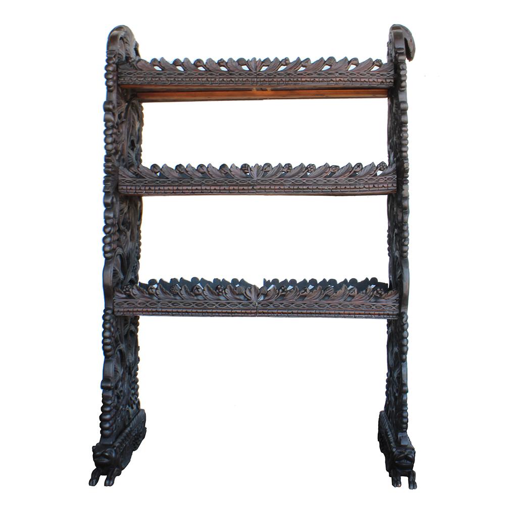 An early 19th century German piece, this Black Forest styled shelving unit has beautiful details in the carved accents covering every inch of the frame and shelves. Indeed, the thematic carving, which features a grape motif, is wrought with such