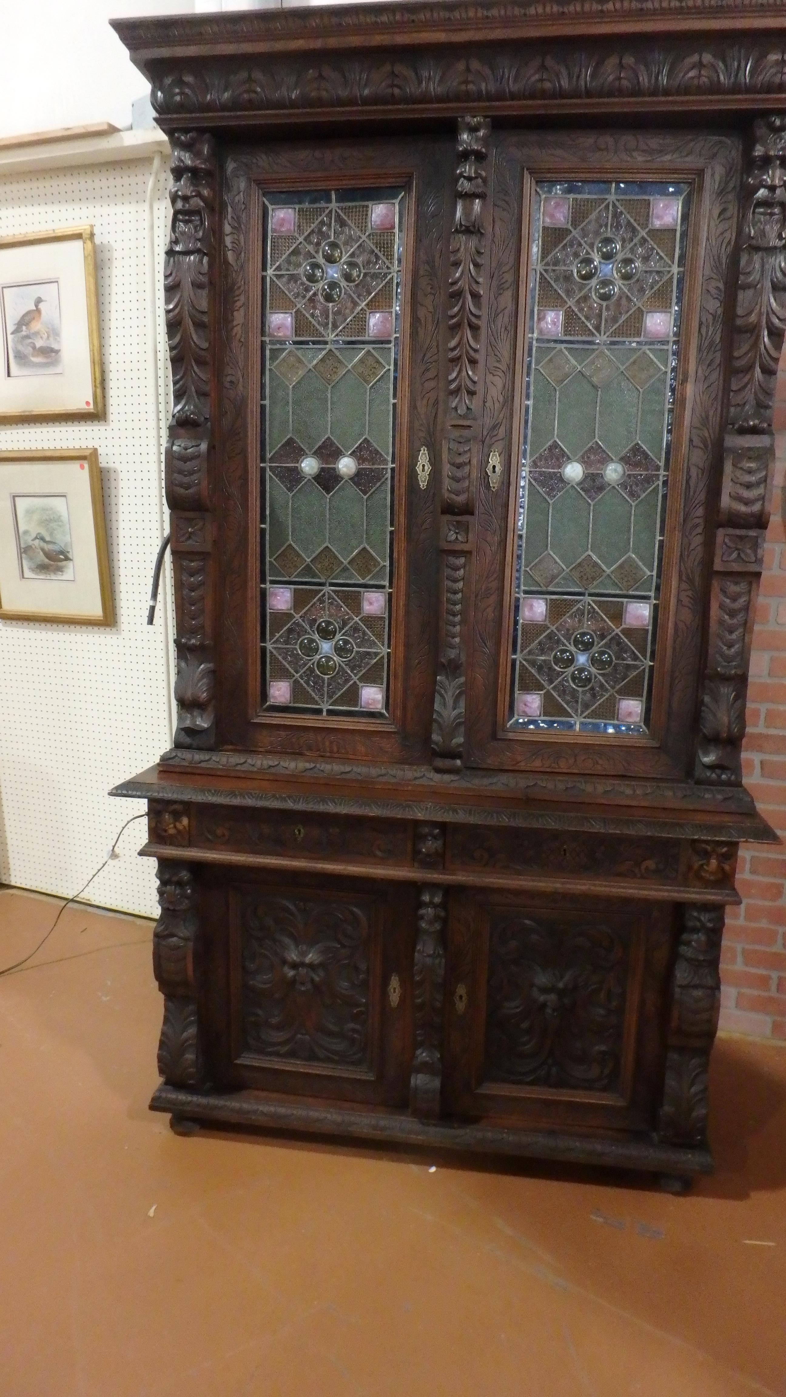 Black Forest Germany early 1800s Renaissance cabinet with hand carving, one of a kind, restored original with three sides stained glass.