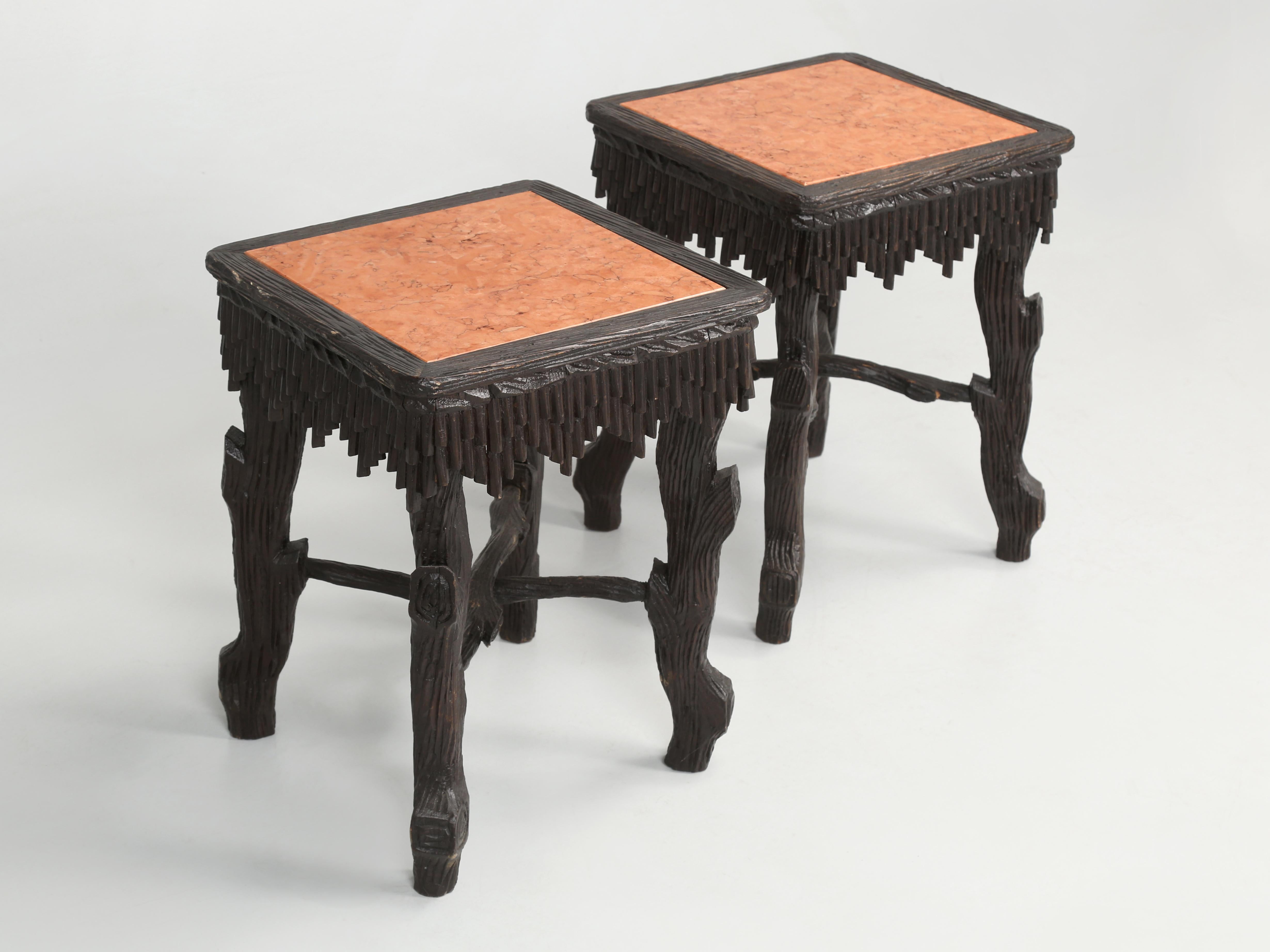 Pair of black forest hand-carved end tables or side tables with marble tops that were made in Switzerland during the late 1800s. Finding one piece of black forest is difficult enough, but locating a pair is unusual to say the least. The history of
