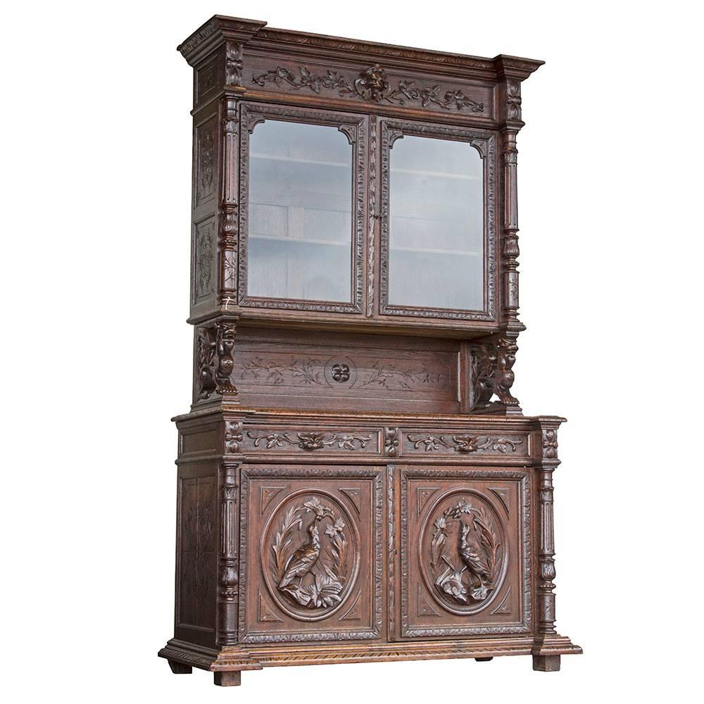 A magnificent example of the Black Forest style, this beautiful two-piece step back hutch is adorned with high relief carvings. As is typical of the style, the carvings exhibit a sylvan theme with game birds as well as various flora and fauna.