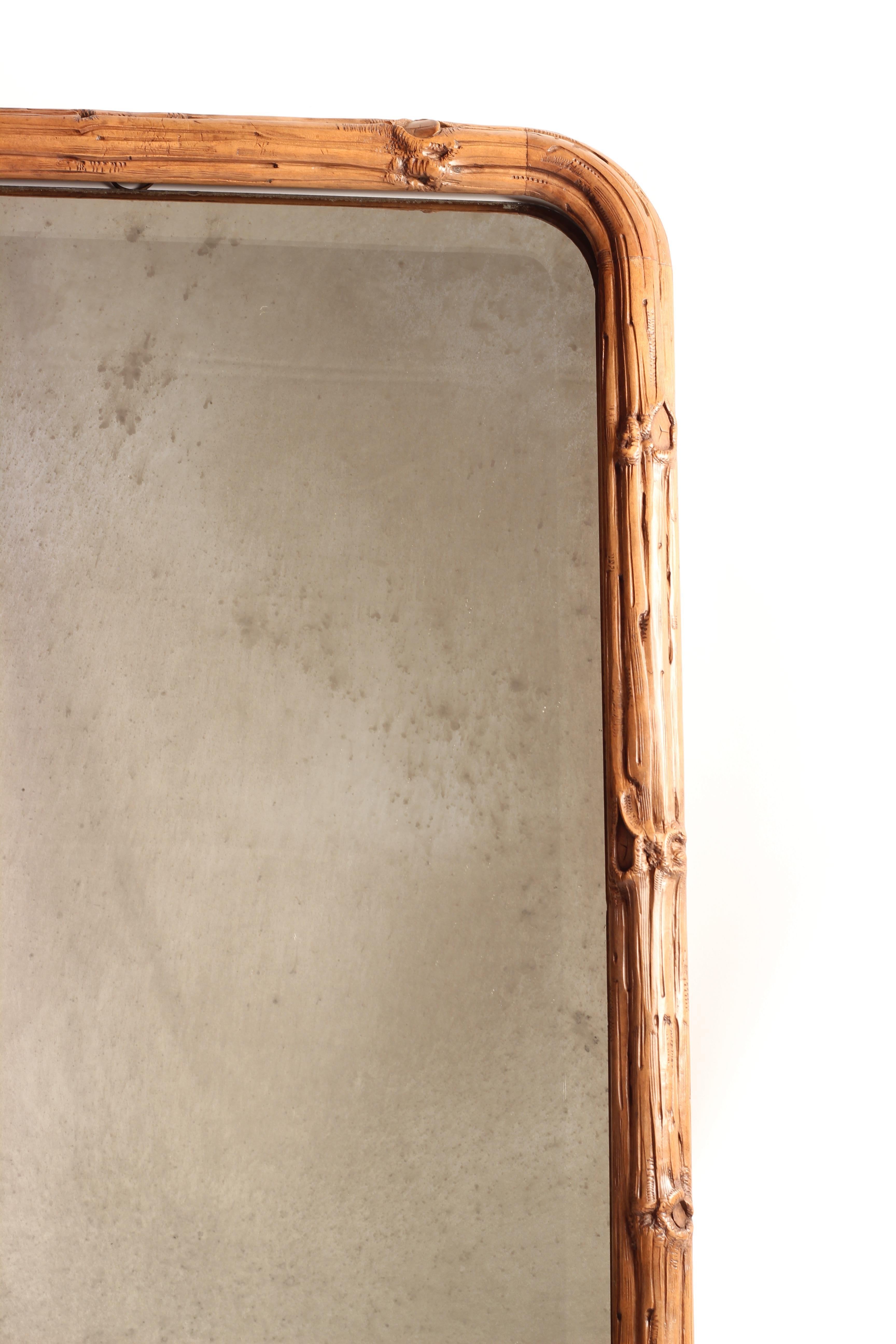 This is one of a pair of incredibly skilfully carved beautiful mirrors, that replicate a border of branches wrapping around a curved bevelled original mirror. The carving is in very good original condition, with the mirror showing no signs of chips
