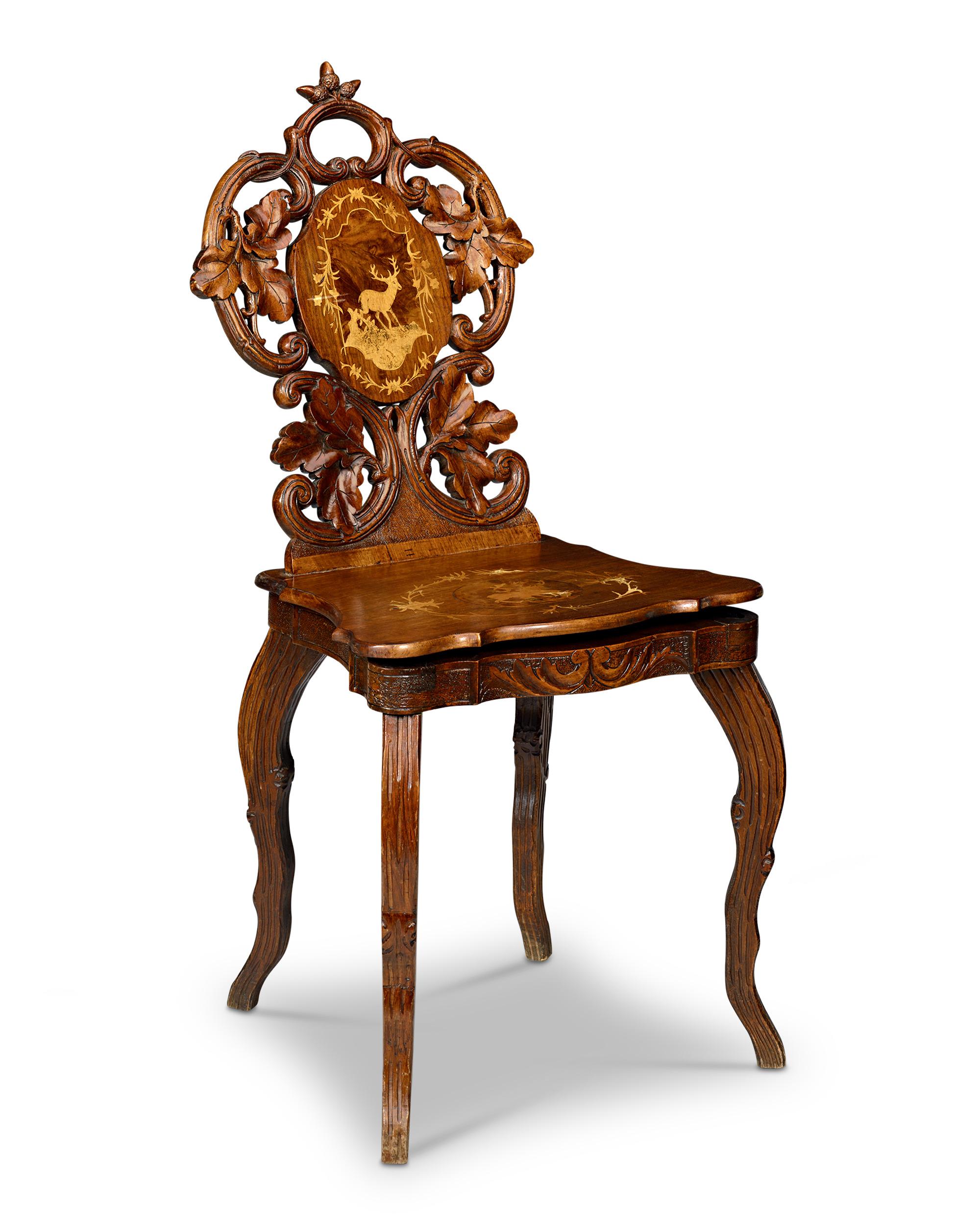 A music box hidden inside this beautifully carved Swiss chair will activate when the chair is sat upon. A remarkable example of the intricate craftsmanship and artistic innovation characteristic of late 19th-century Brienz, Switzerland, this chair