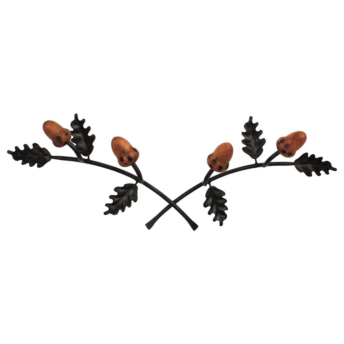 Iron and Wood Wall Coat Rack, Spain, 1960s
Eye-catching rustic style hats an coats rack with oak leaves iron backplate and wood acorn hangers.
This wall coat rack features two branches of oak tree in iron with 2 carved wood hangers each.
This piece