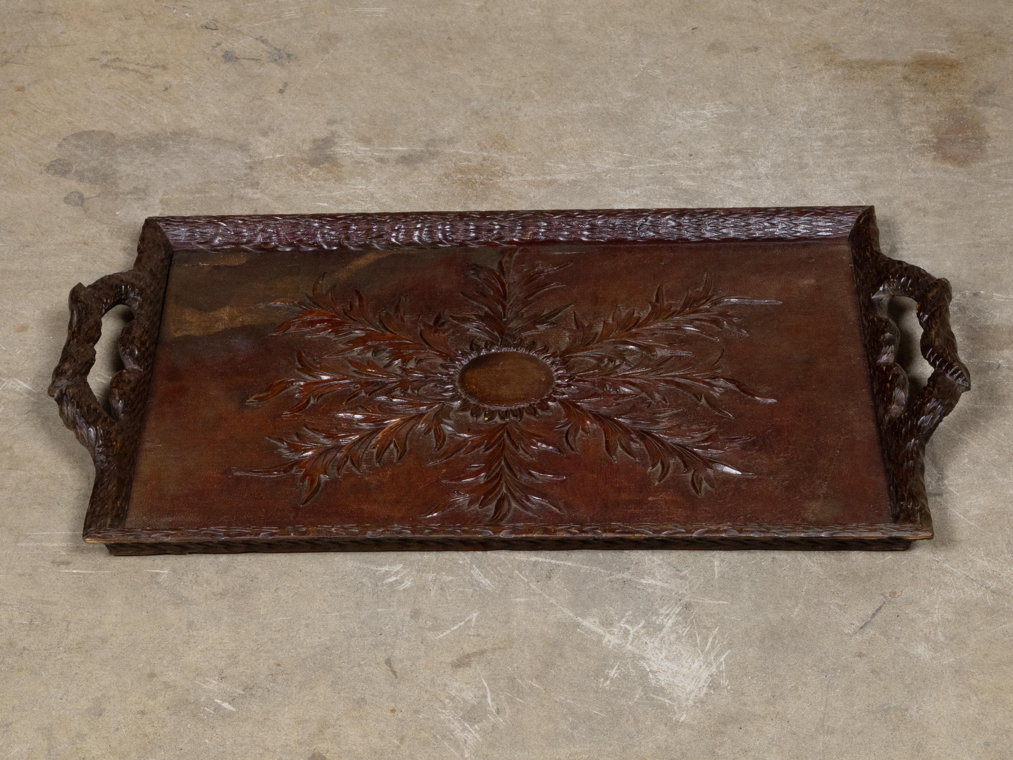 A richly carved Black Forest serving tray in oak, dating to the late 19th century, circa 1880. This hand-carved piece showcases the traditional craftsmanship associated with the Black Forest region, distinguished by its sculptural depth and