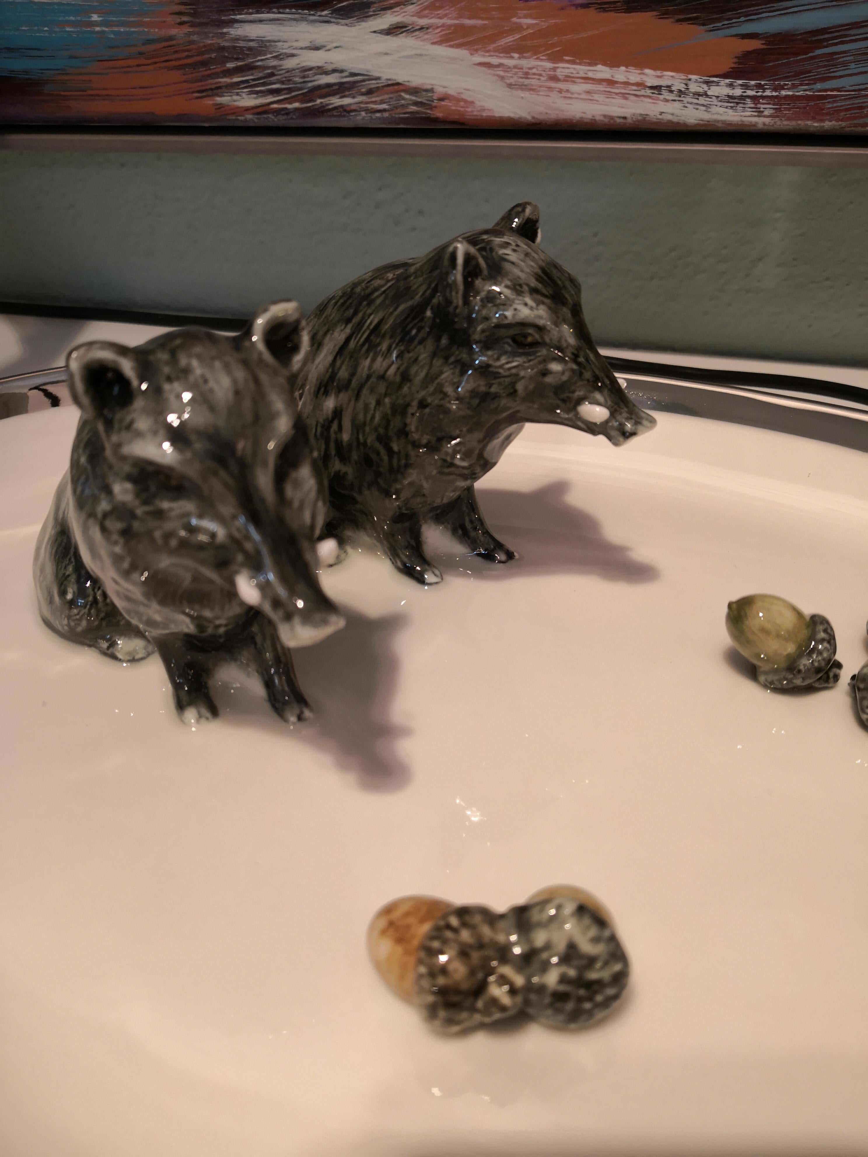 Completely handmade and hands-free painted large oval porcelain plate for decoration. Two natural moulded porcelain figures wild boars are sitting on the side decorated with fixed oaks on the porcelain plate. The plate is rimed with a platinum line.