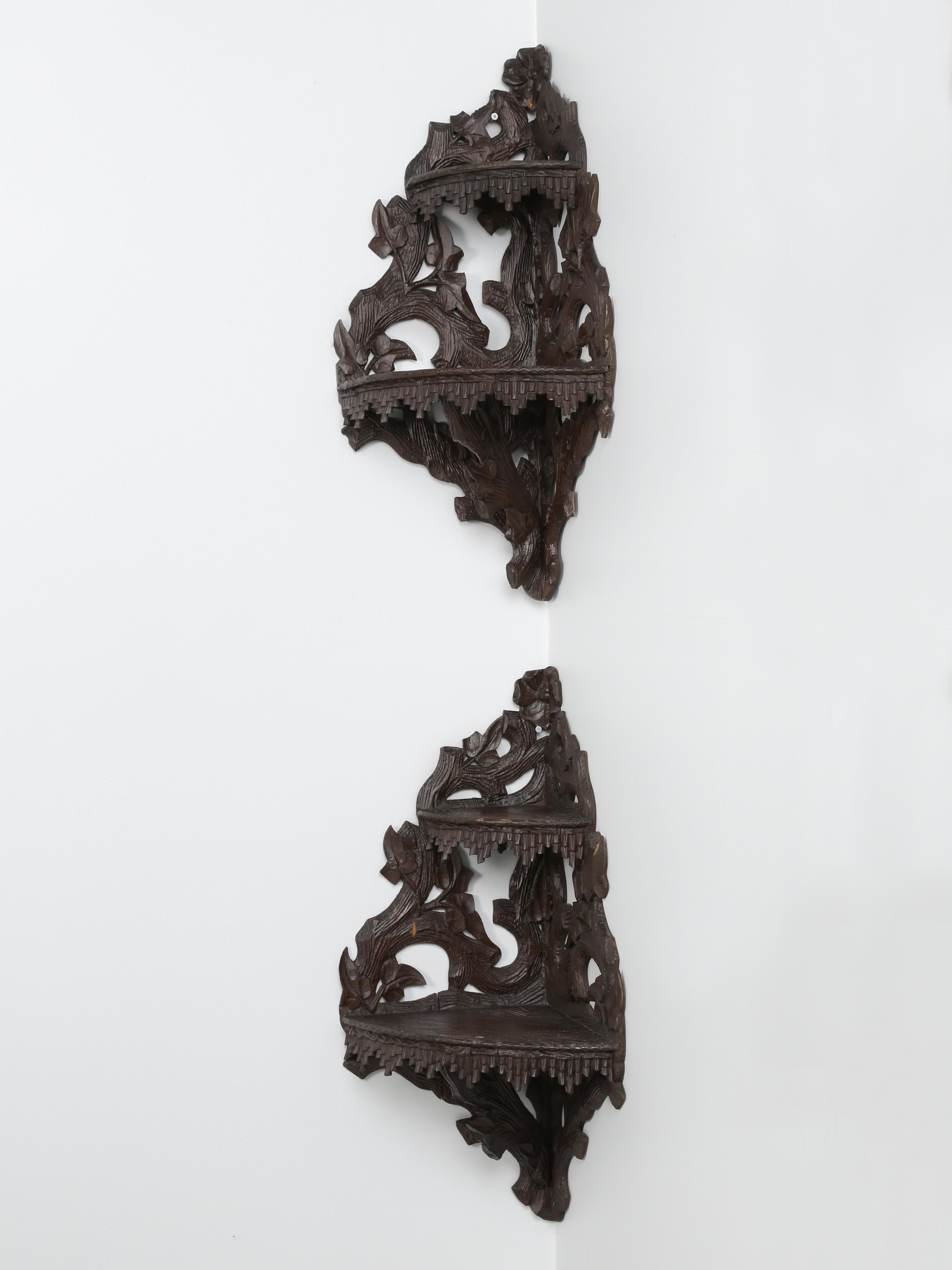 Black forest pair of hanging corner shelves, hand carved in Switzerland between 1860 and 1890. The black forest hanging corner shelves are quite unusual with their original intricate carving. Black Forest Furniture began to appear in the mid-1800s