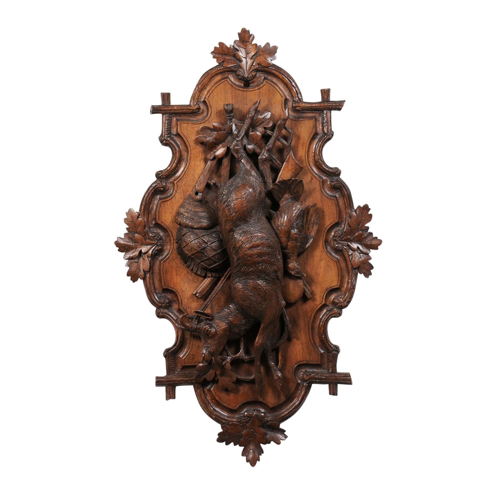 A Black Forest period German wall carving from the 19th century depicting a hunting trophy. A striking relic from the 19th century, this Black Forest period German wall carving serves as a tangible bridge between history and the modern-day art