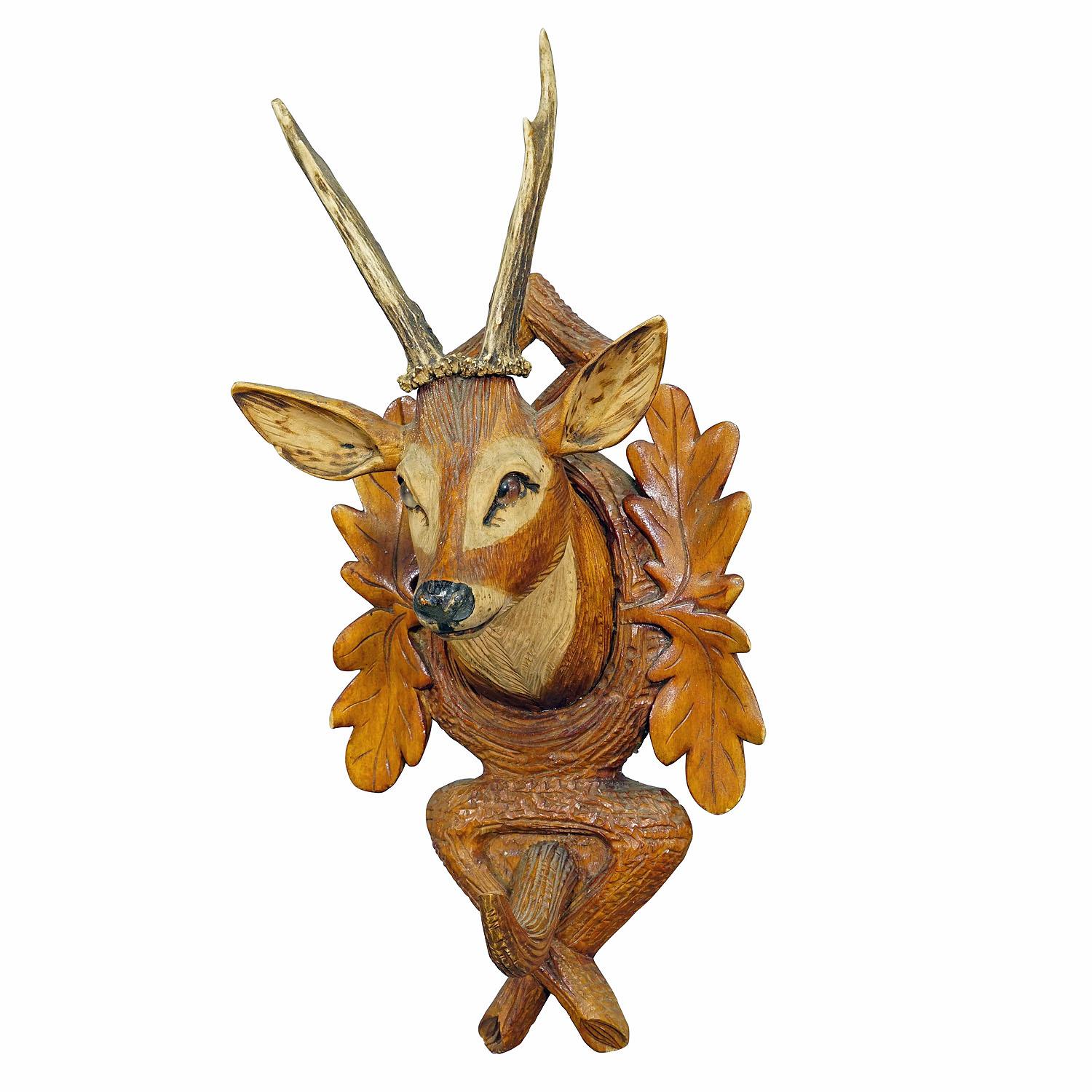 Black Forest Rustic Carved Wooden Coat Hook with Deer

A nice handcarved whip holder or coat rack featuring a wooden carved deer head with real deer tropies. A classical carving art made in Brienz, Switzerland circa 1920. The antique whip holder is
