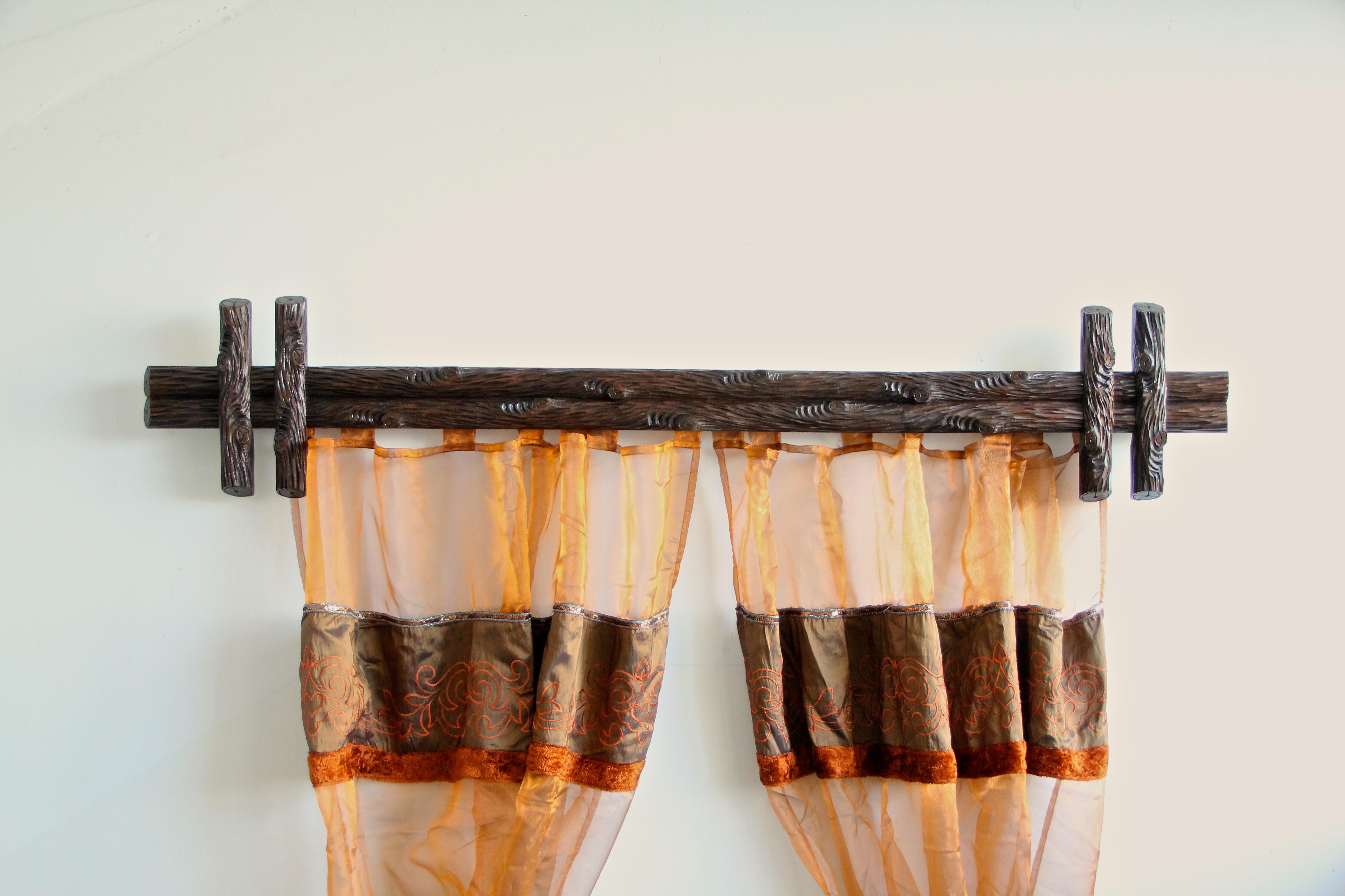 Extraordinary rare pair of Black Forest rustic curtain rods from the late 19th century in Germany, circa 1880. These artfully hand carved curtain rods impress with a very unique 