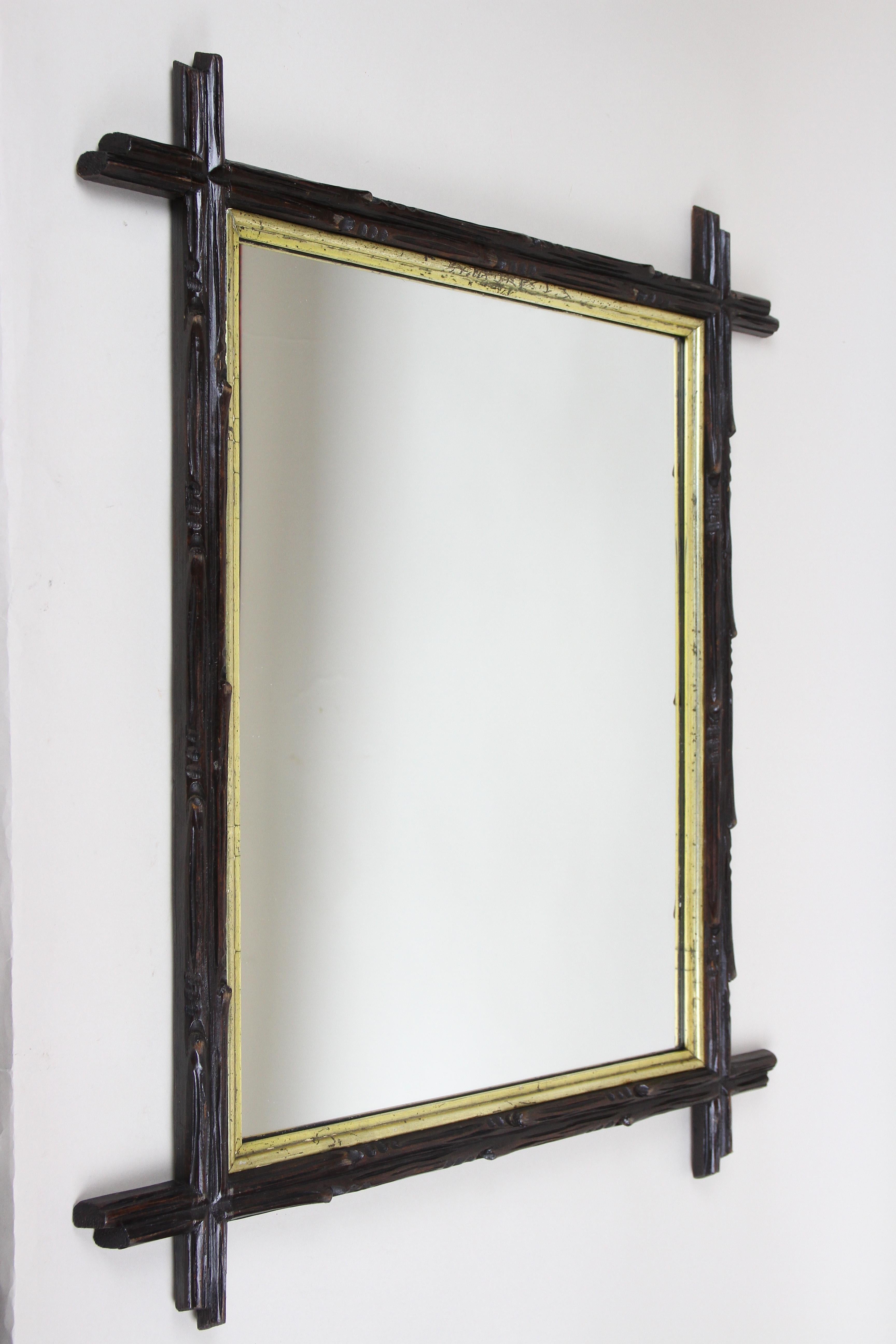 Extraordinary rustic Black Forest wall mirror from the period in Austria around 1880. Elaborately hand carved out of basswood, this fantastic rural mirror impresses with its artfully carved frame in the style of tree branches, slightly protruding