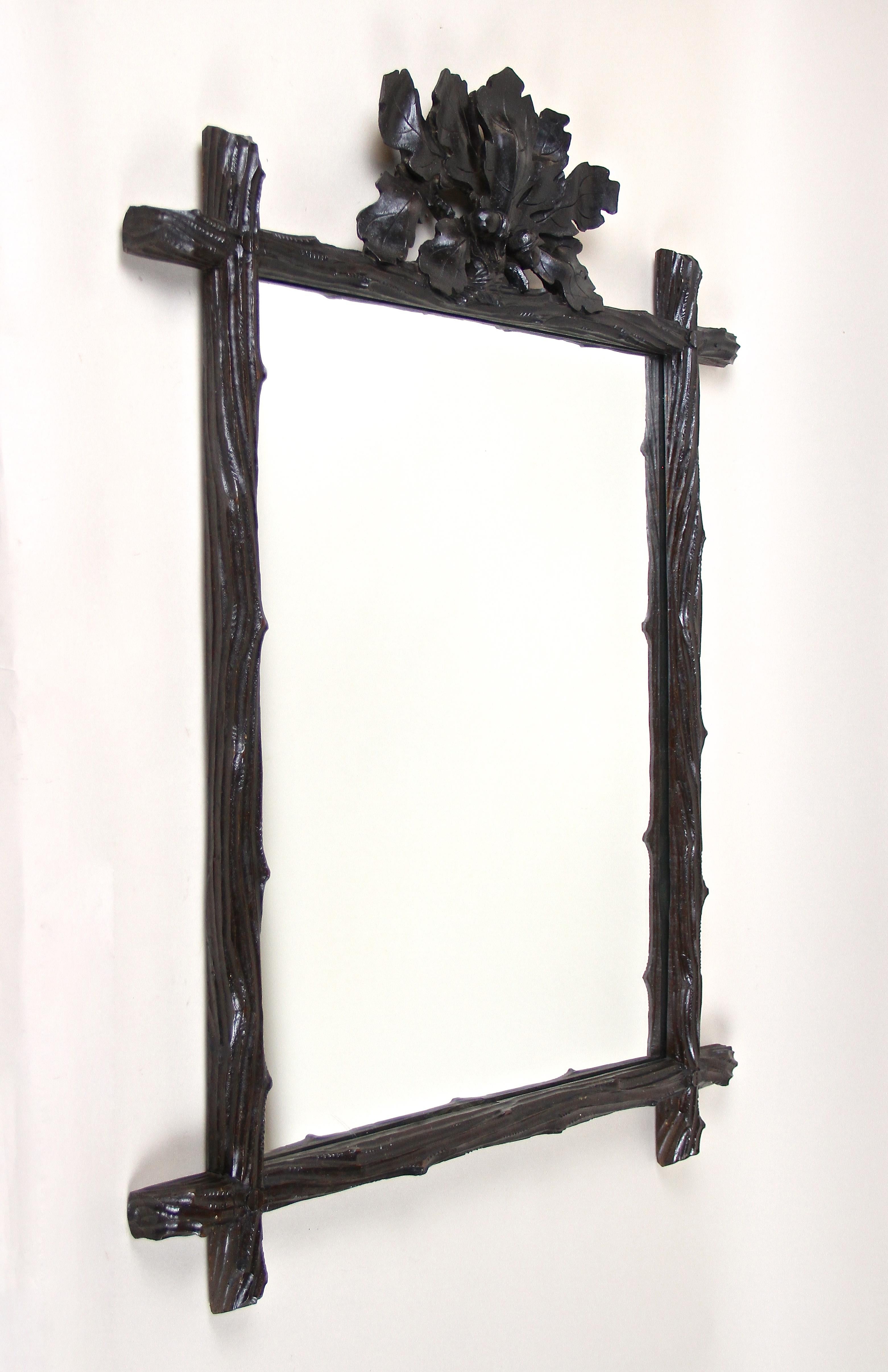 Exceptional Black Forest Mirror from the late 19th century in Austria around 1870. This phenomenal, elaborately hand carved rustic wall mirror impresses with its simple but artfully designed 