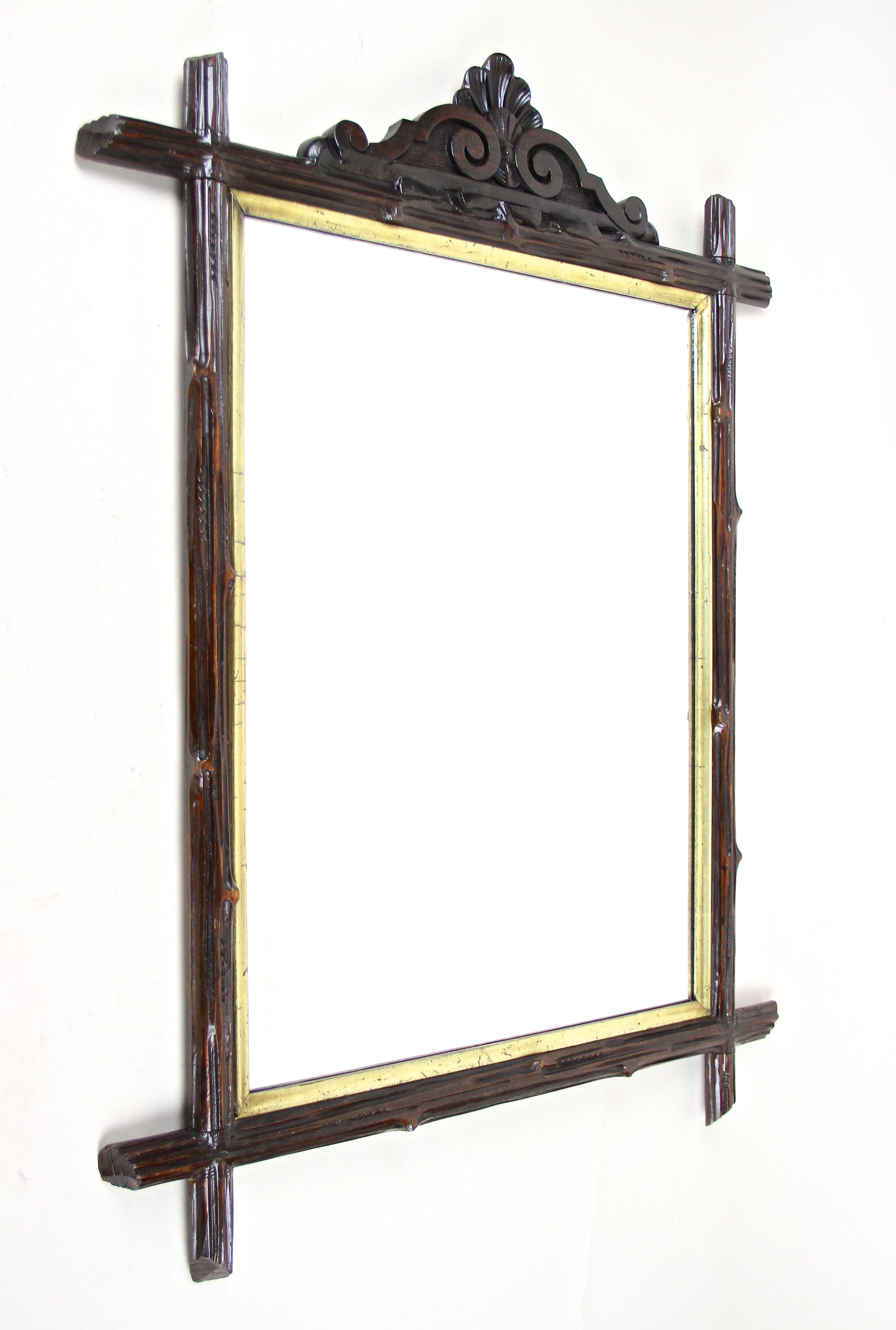 Amazing rustic Black Forest wall mirror from the late 19th century in Austria. Elaborately handcrafted around 1880 this rural mirror shows an absolute unique design. The hand carved basswood frame was created in the manner of tree branches.