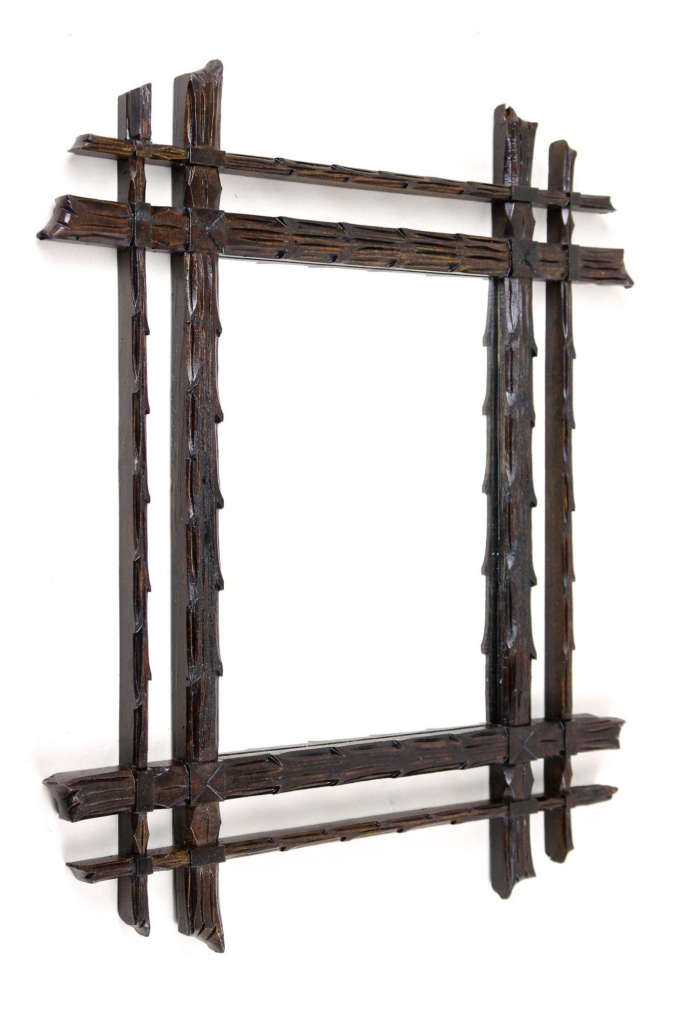 Extraordinary rustic wall mirror from the 19th century around 1870 in Austria. An unusual piece of a Black Forest mirror that has been elaborately handcarved out of basswood in an exceptional style. The main frame has been creafted in a very
