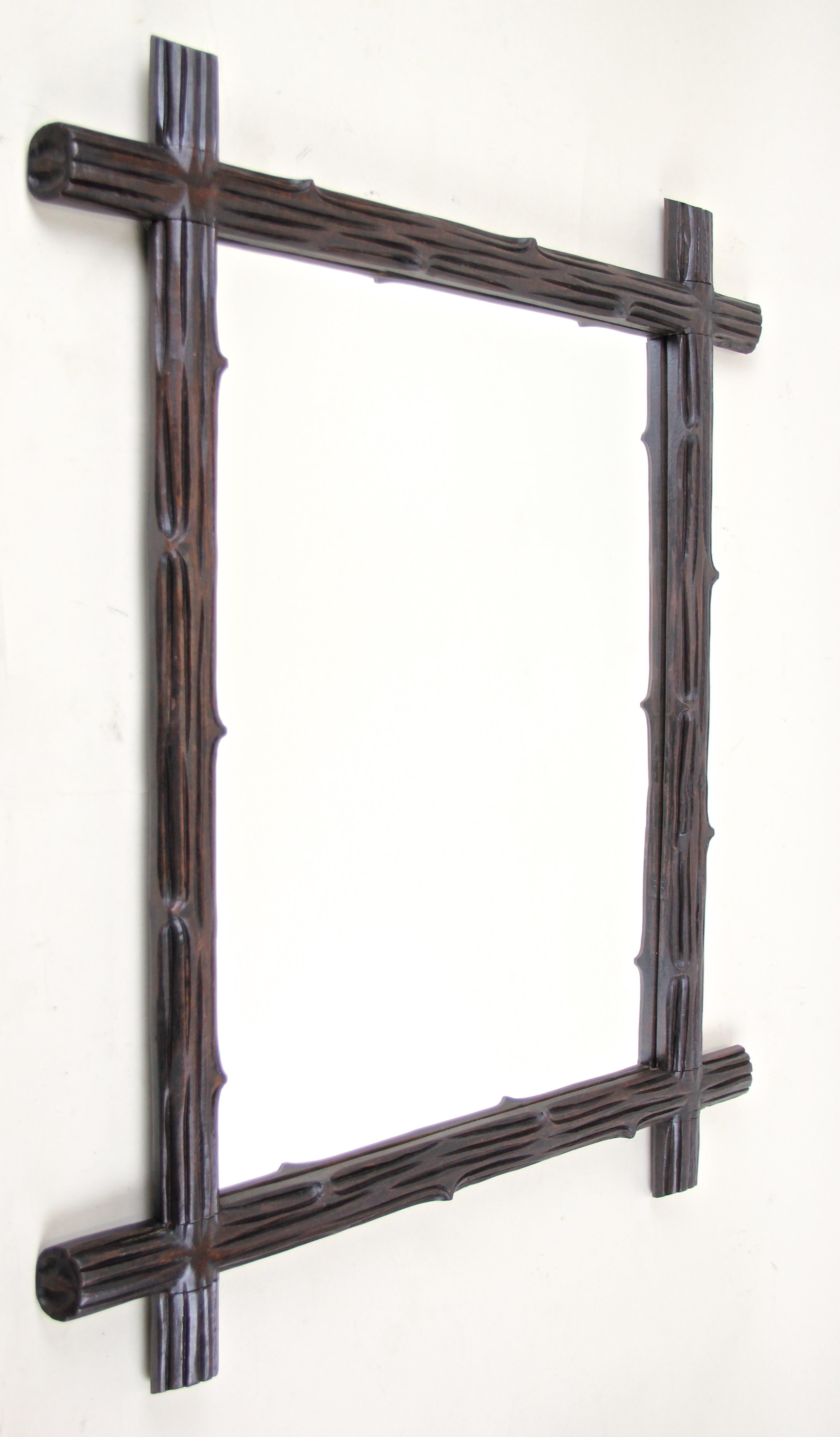 From circa 1890 in Austria comes this hand carved wooden Black Forest wall mirror. A simple but elegant 