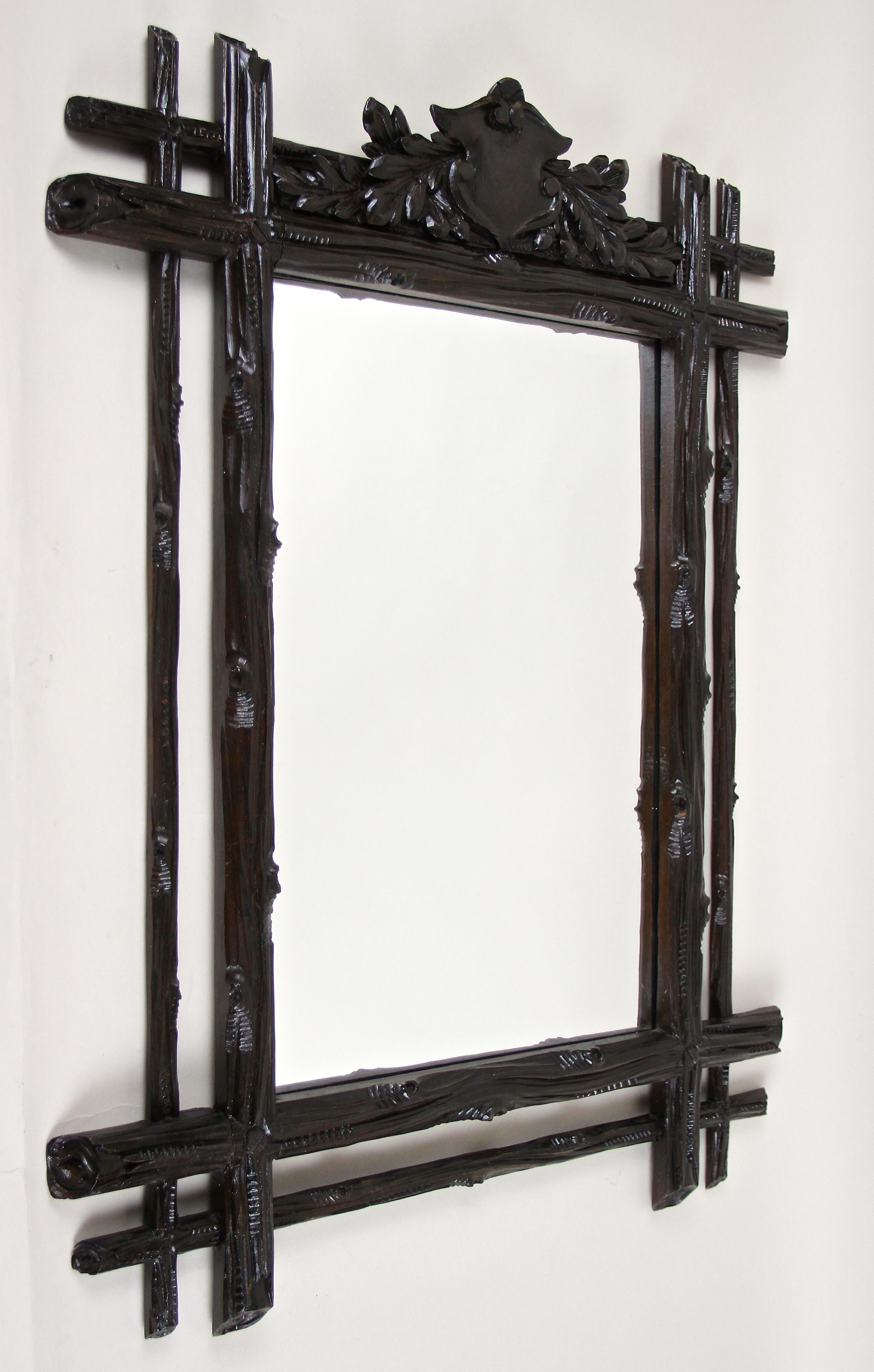 Fantastic looking rustic Black Forest wall mirror from the late 19th century in Austria around 1870. Hand carved out of fine basswood this rural mirror shows an absolute amazing design. The doubled frame with protruding corners impresses with a