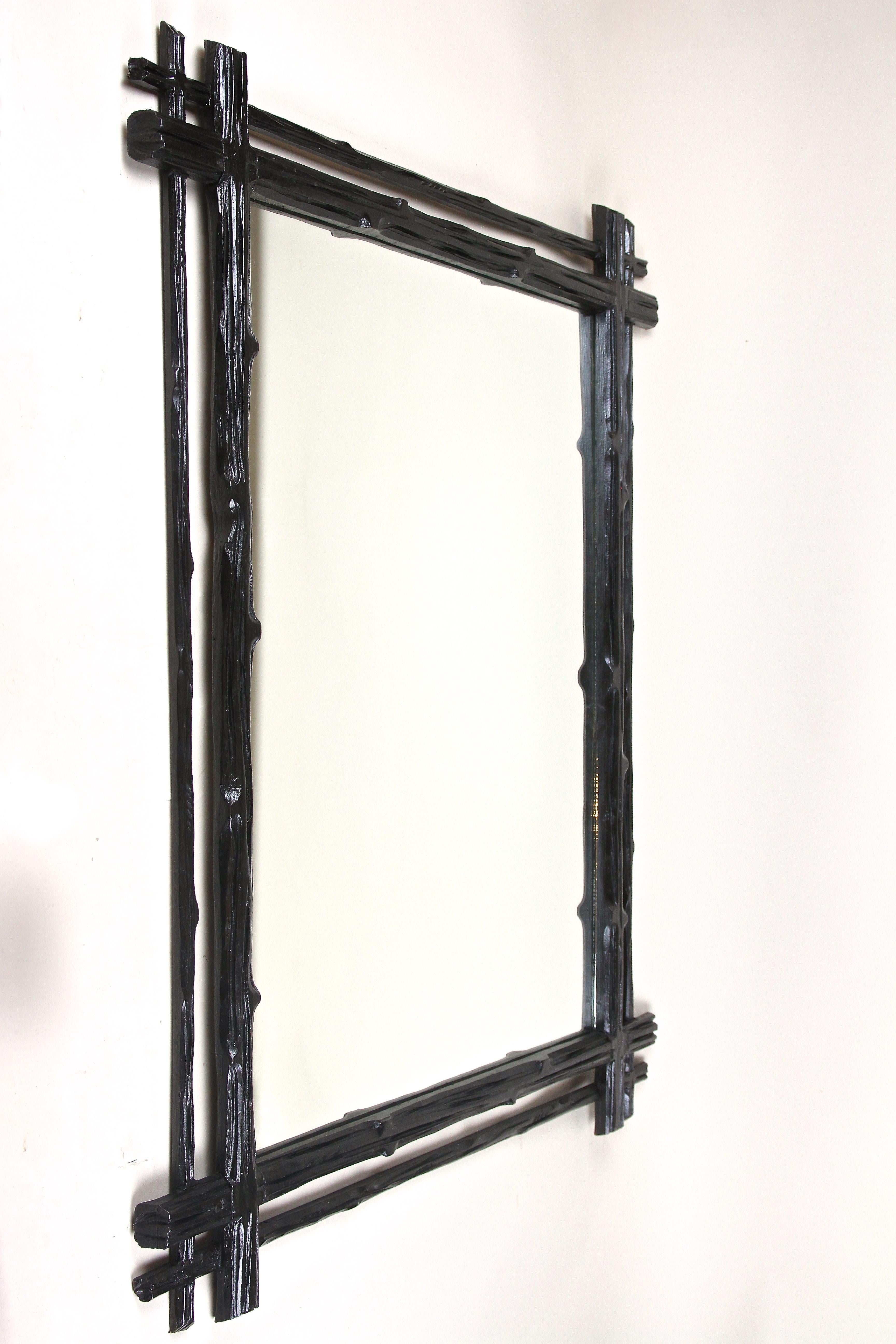 Exceptional large carved Black Forest Wall Mirror from the late 19th century around 1880 in Austria. This beautiful rustic Black Forest mirror has been elaborately hand crafted out of basswood and comes with an almost black varnished surface. Framed