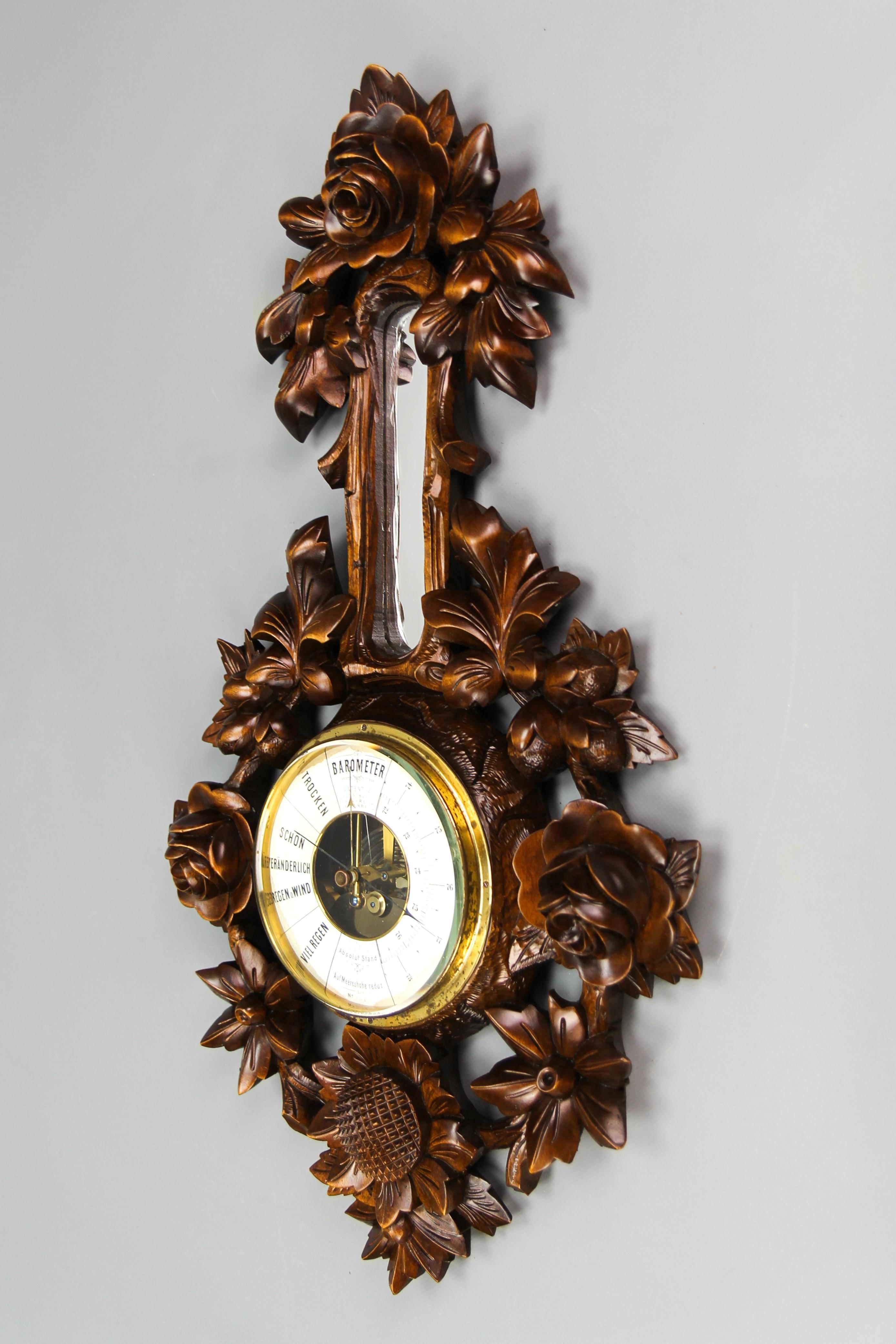 Black Forest style carved walnut barometer, Germany, ca. 1920.
An impressive carved walnut barometer with masterfully carved flowers and leaves. A small mirror on the top of the round barometer.
In good condition with slight signs of aging and