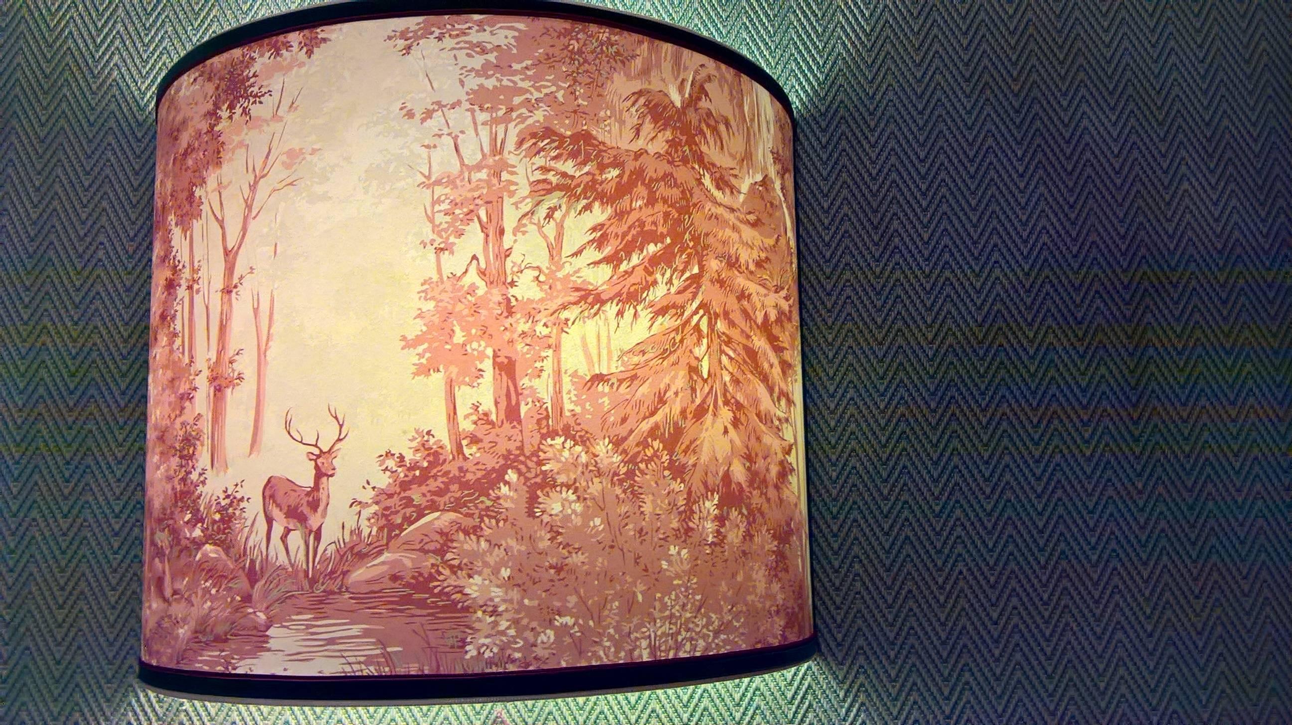 Großer handgefertigter Lampenschirm aus Tapete mit einer Jagdszene in Rot und Beige im Stil des Schwarzwaldes. Handgefertigt in Österreich. 
Behoben mit grünem und rotem Paspol. Zwei handgefertigte Eisenwinkel für die Stromzufuhr werden mit den