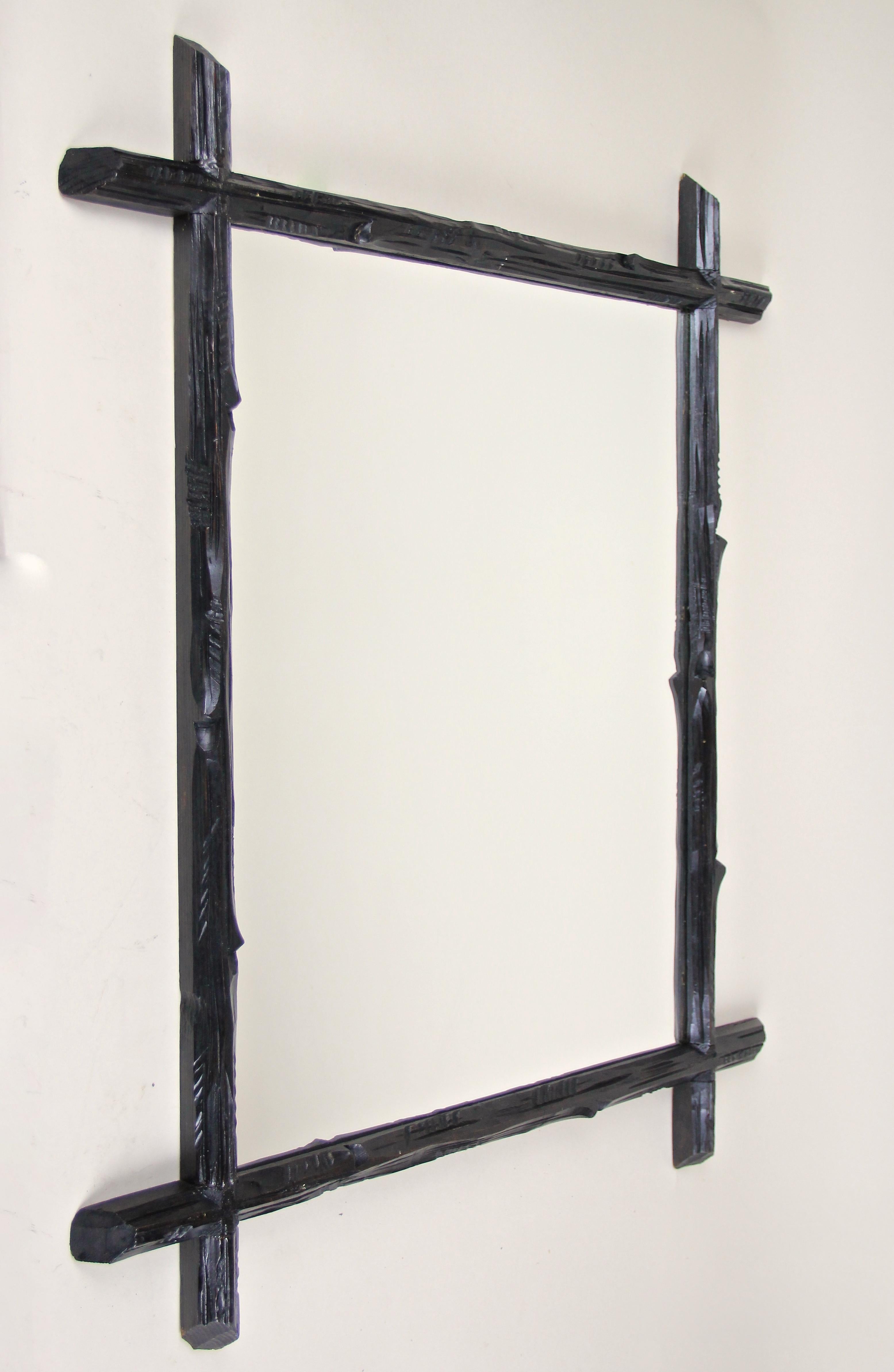 Decorative rustic Black Forest wall mirror from the late 19th century circa 1880 in Austria. A unique lovely hand carved frame impressing with an unusual 