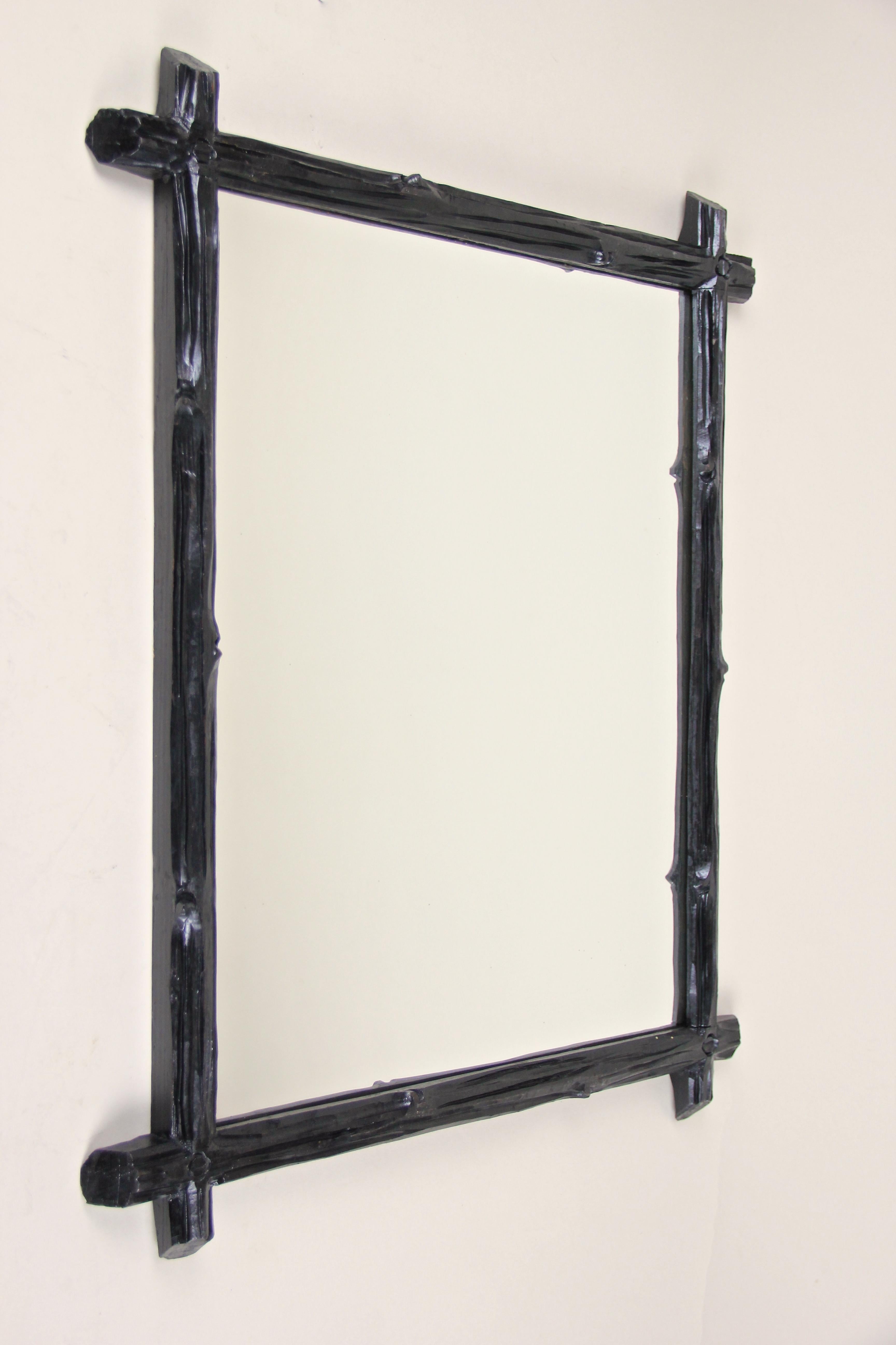Rustic designed Black Forest wall mirror from Austria, circa 1880. This exceptional antique wall mirror impresses with a simple but elegant 