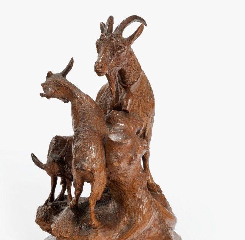 A charming small ‘Black Forest’ wood carving of a mountain goat and her kids.
   