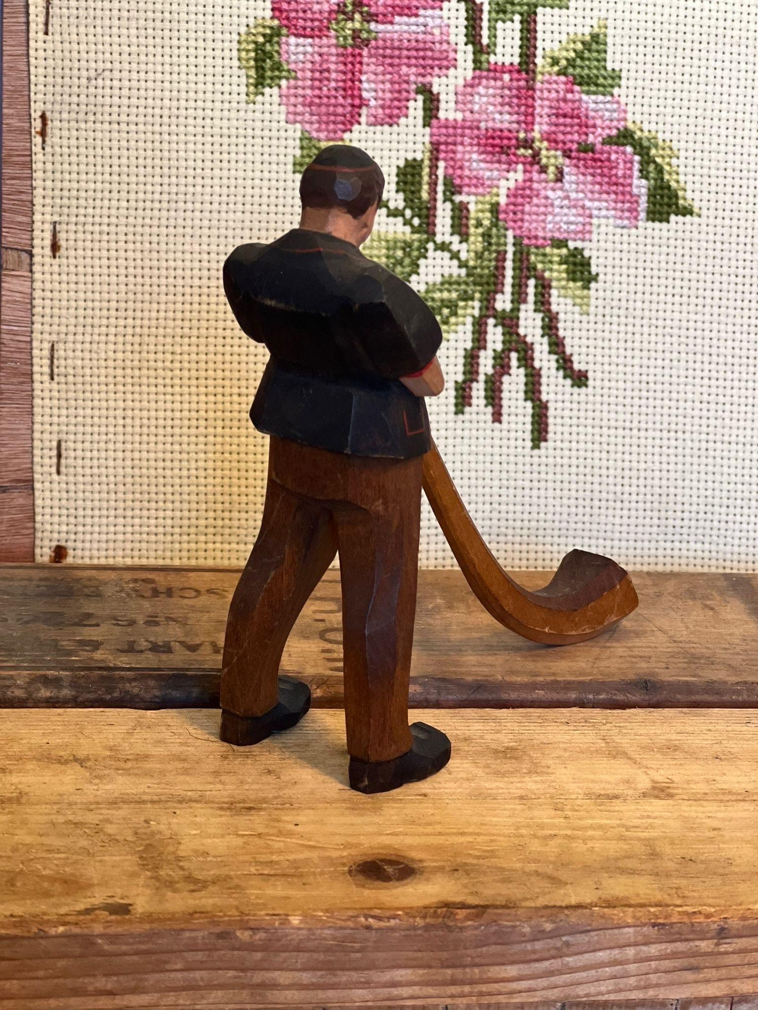 Mid-Century Modern Black Forest wood carving of man blowing a swiss horn For Sale