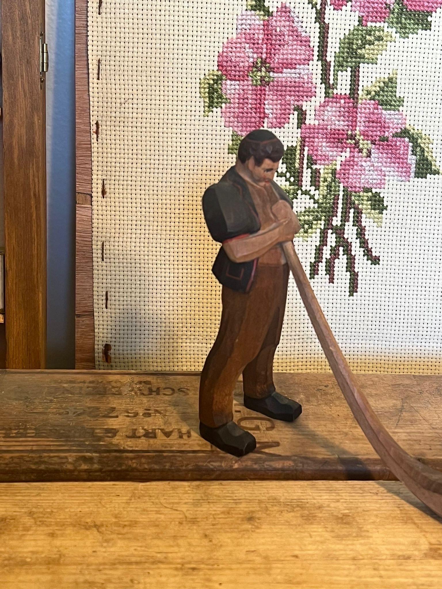 Black Forest wood carving of man blowing a swiss horn In Good Condition For Sale In Seattle, WA