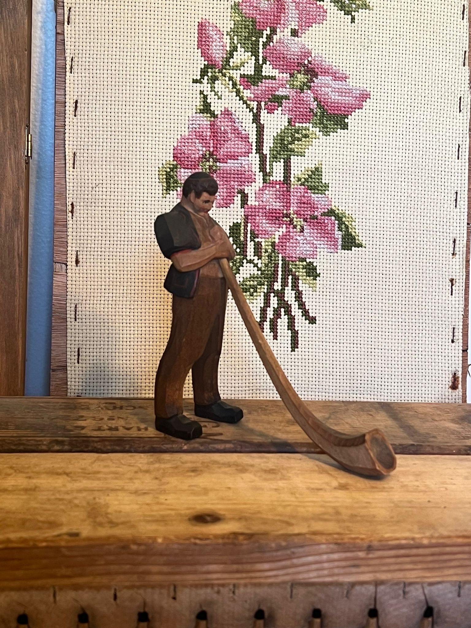 Late 20th Century Black Forest wood carving of man blowing a swiss horn For Sale