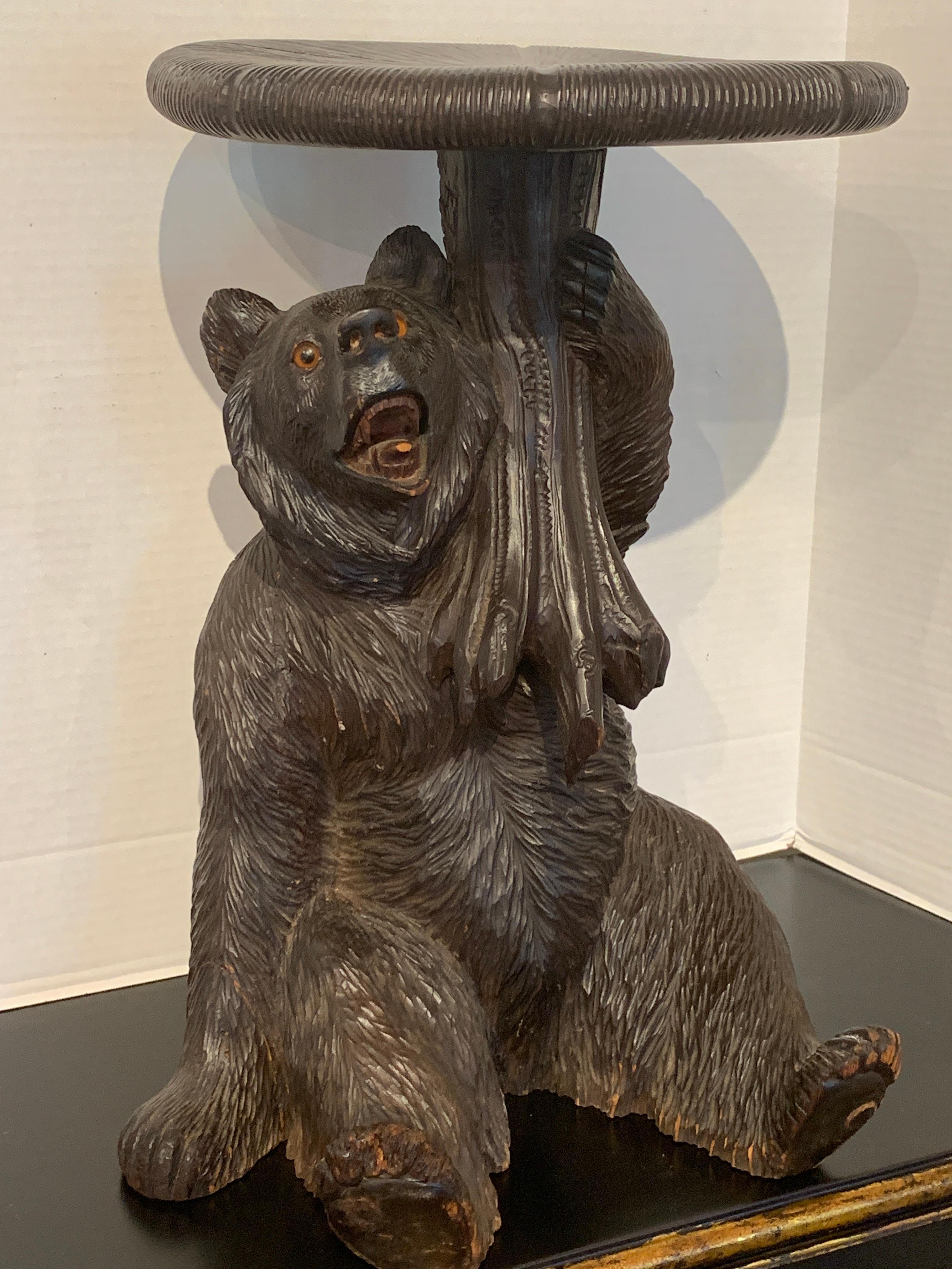 Black Forest carved bear with mushroom stool/ table, realistically carved figure of a seated bear with a 13