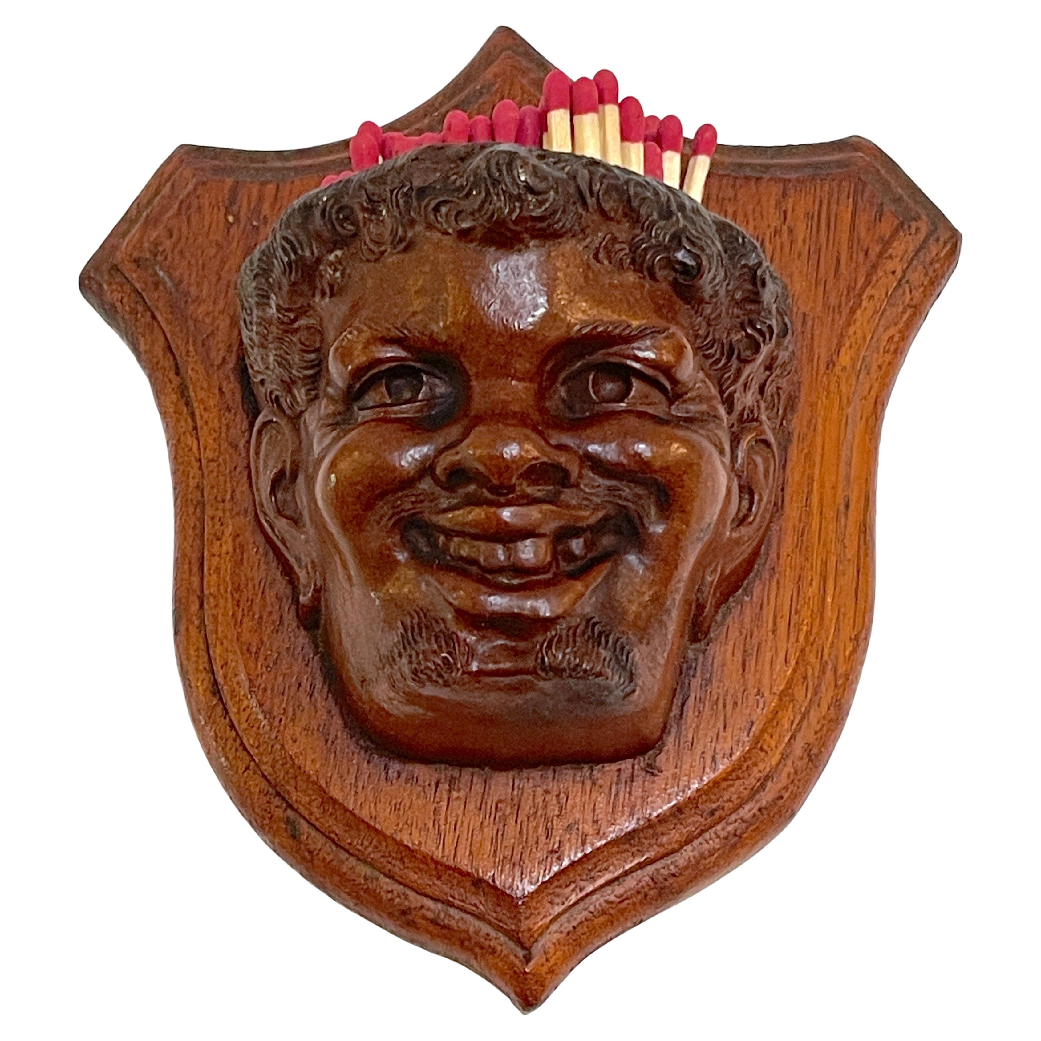 Black Forrest Carved Black Walnut Toothless Man Motif Hanging Match Holder
Swiss, Later 19th Century 

A whimsical and intricately hand-carved piece from the Black Forest region, this hanging match holder features a realistically carved black walnut