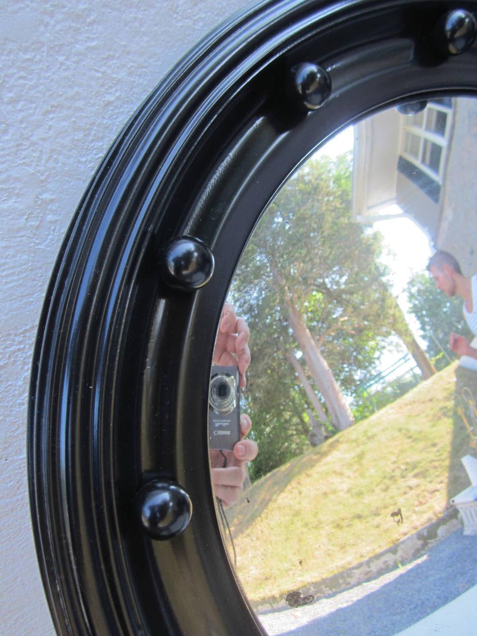 19th Century convex mirror in black painted frame.