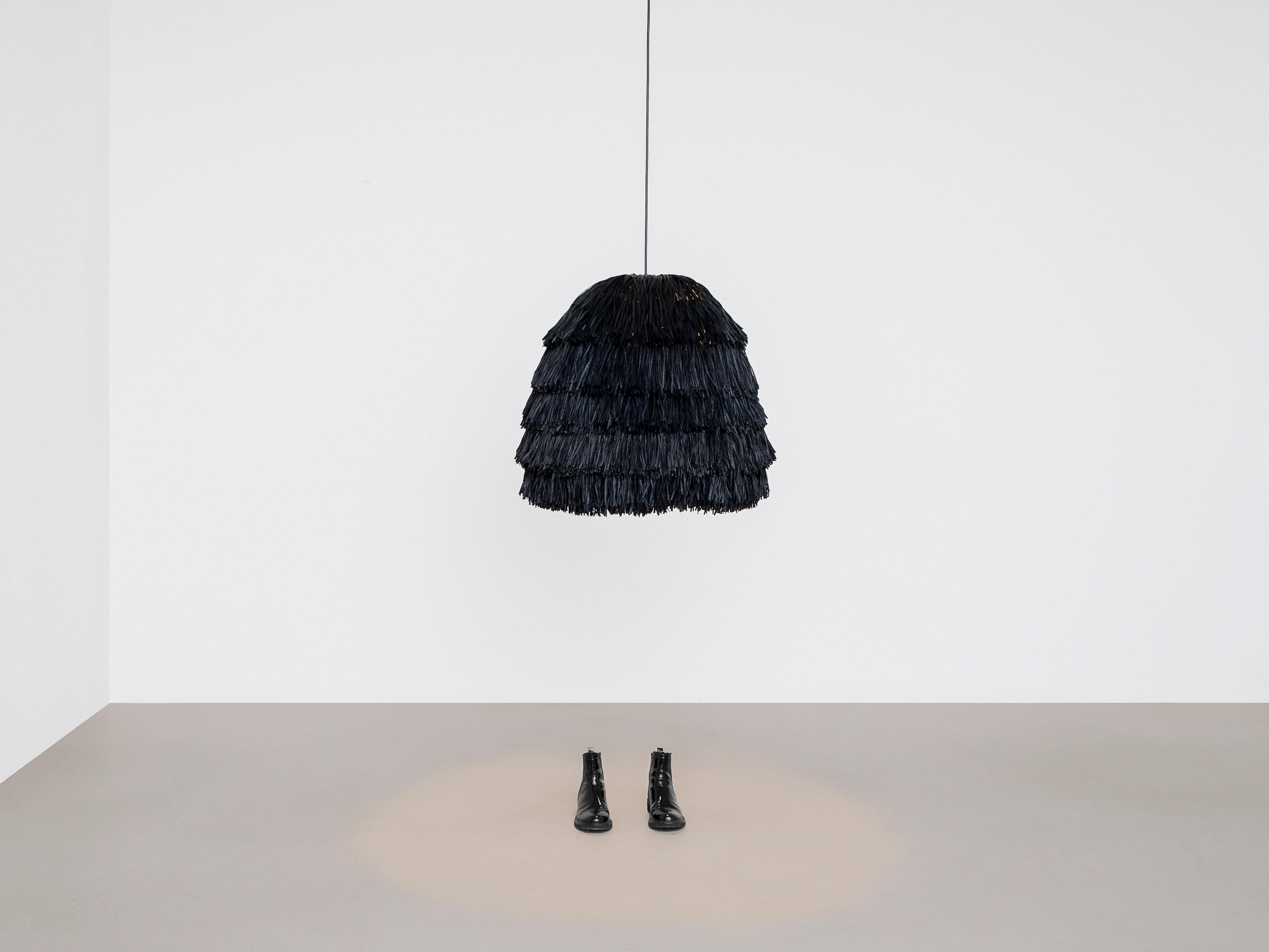 Black Fran XL lamp by Llot Llov
Handcrafted Light Object
Dimensions: Ø 65 cm x H: 70 cm
Materials: raffia fringes
Also available in green, red, black, beige 

With their bulky silhouette and rustling fringes, the FRAN lights are reminiscent of a