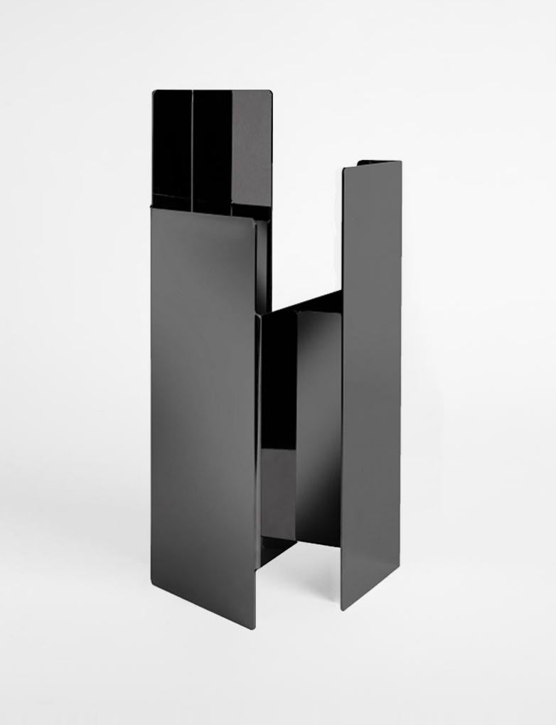 Black Fugit vase by Mason Editions.
Dimensions: 12 × 15 × 34 cm
Materials: Iron 
Colors: matte bronze, polished white nickel, black nickel

Fugit vase consists of a metal sheet that seems to turn and close around itself, generating an