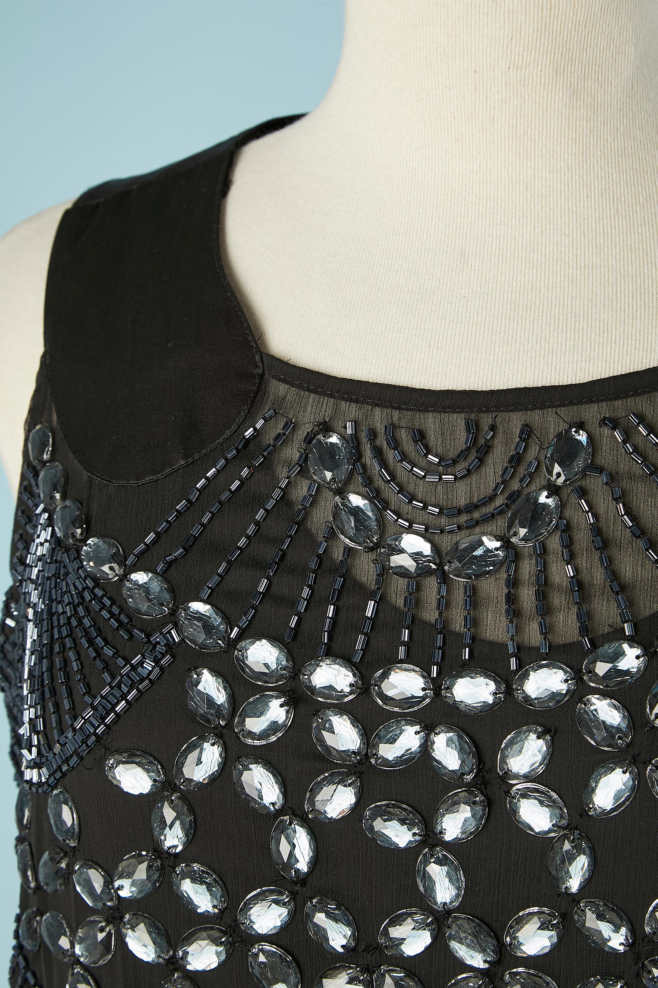 Black full beaded sleeveless cocktail dress. Shell composition: 100% polyester + beads and rhinestone. Lining: 100% rayon 
SIZE: 8 US 