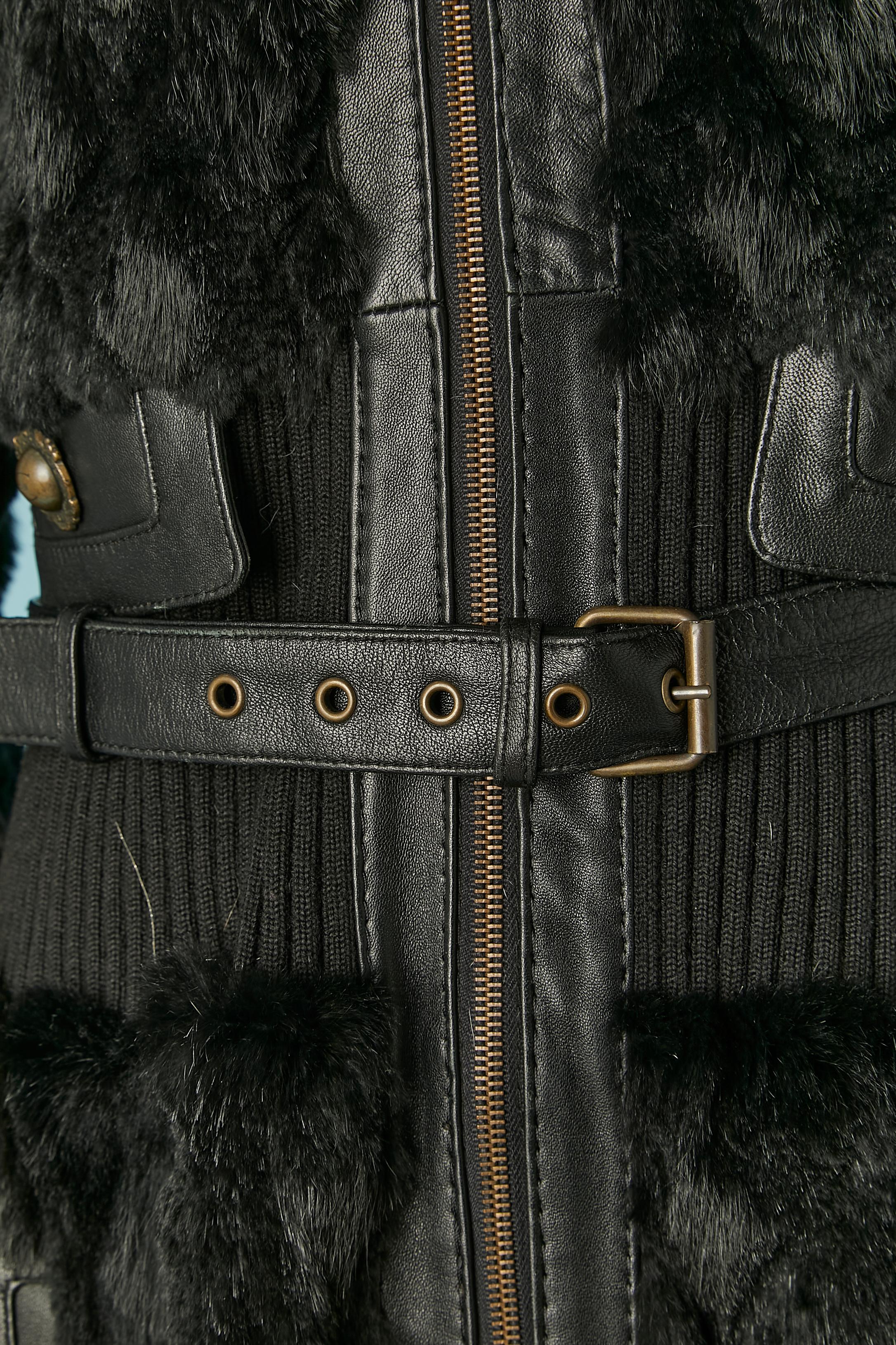 Black fur coat with ribbing edge ( collar, cuffs and waist) and leather belt. 
No fabric composition tag but the fur is probably rabbit, the ribbing is probably wool and stretch and the lining is probably rayon. Zip closure in the middle front with