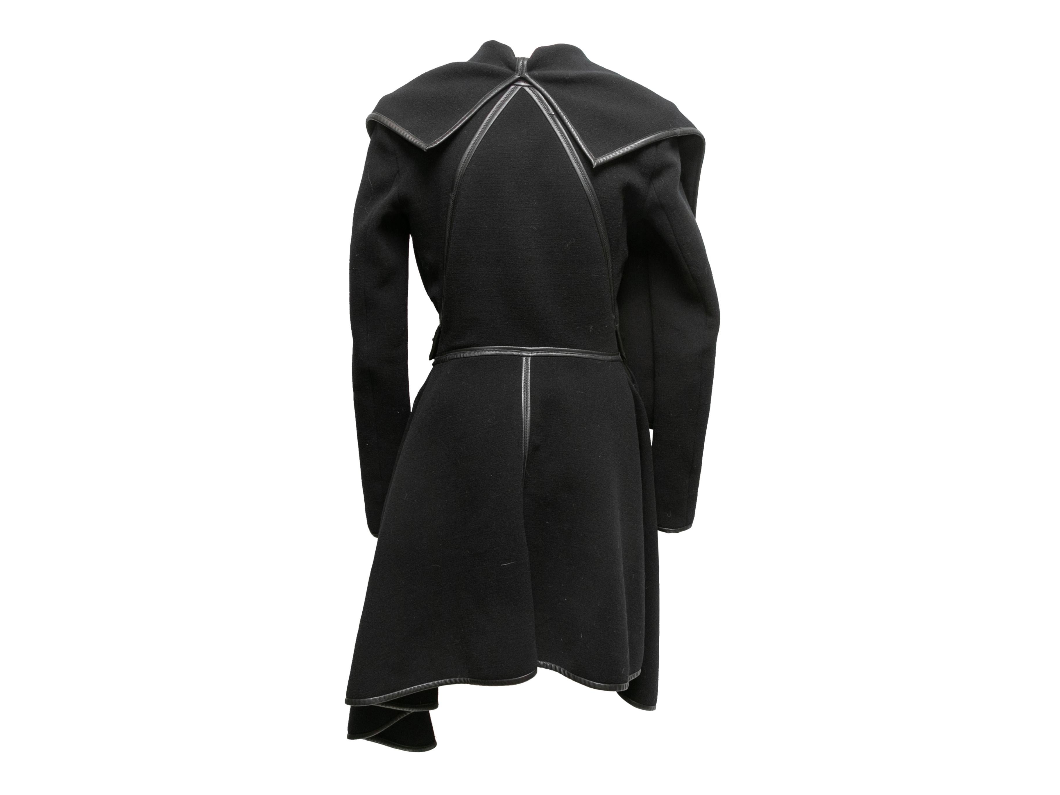 Black wrap coat by Gareth Pugh. Leather trim. Sash tie closure at waist. 34