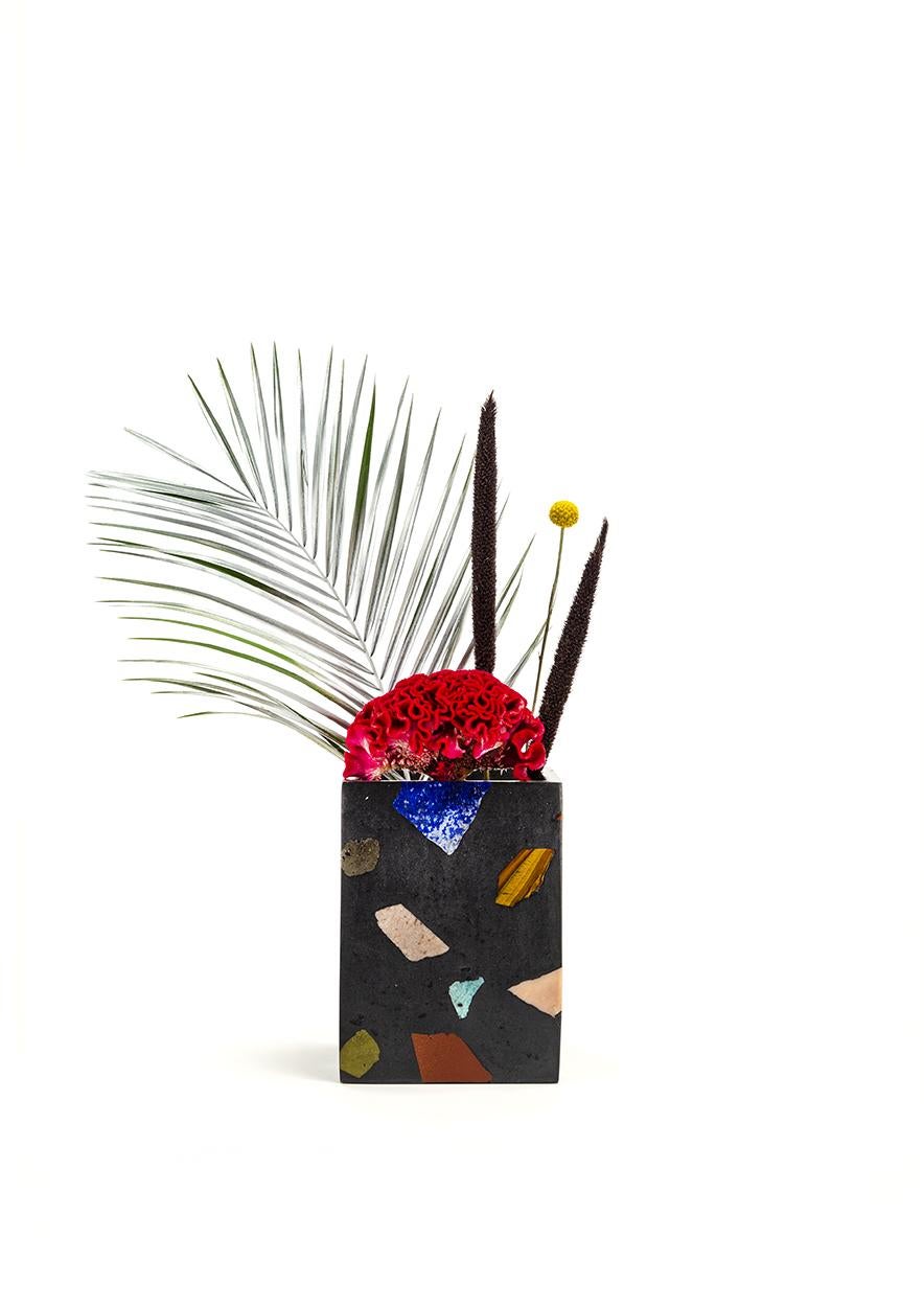 A long tall vase, Deep Field is a jet black colorway featuring Lapis, Rhodochrosite, Phosphosiderite, Goldstone, Agate, and other brightly colored stones. Each vase is cast in our proprietary gemstone terrazzo material and finished in our Portland
