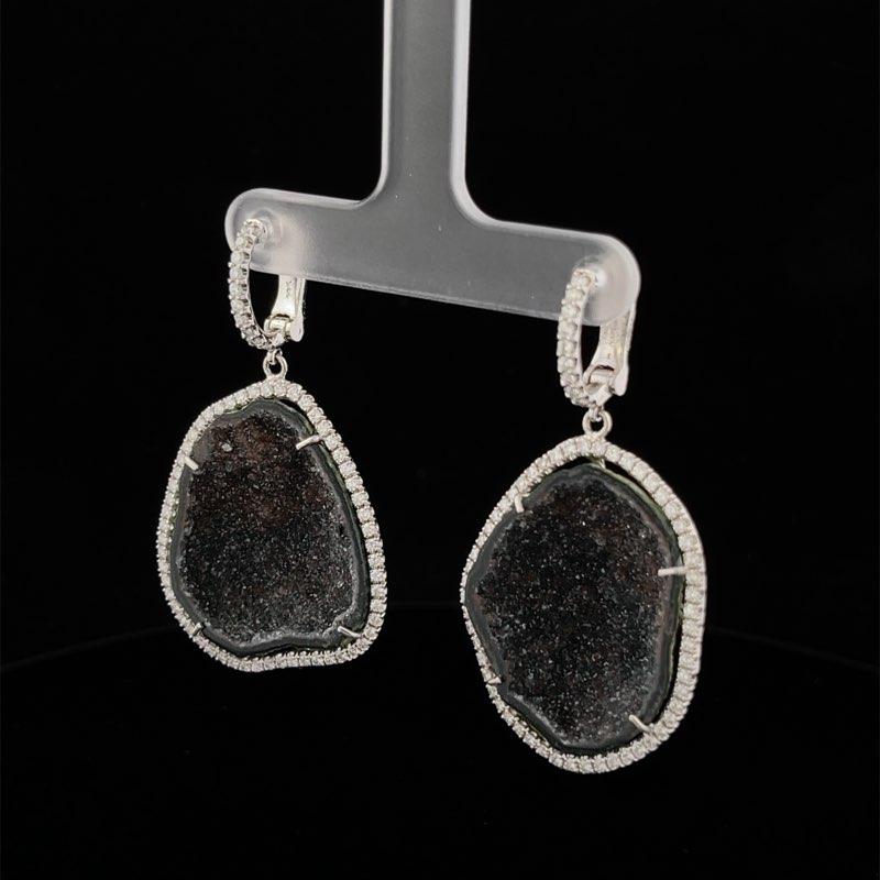 Gorgeous Black Geode Dangle Earrings! These earrings are made in 14K White Gold with Two (2) Rough Cut Black Geodes. The stones are surrounded by diamond halos that included 132 Round Diamonds Weighing 1.31CTW. They are just under 2