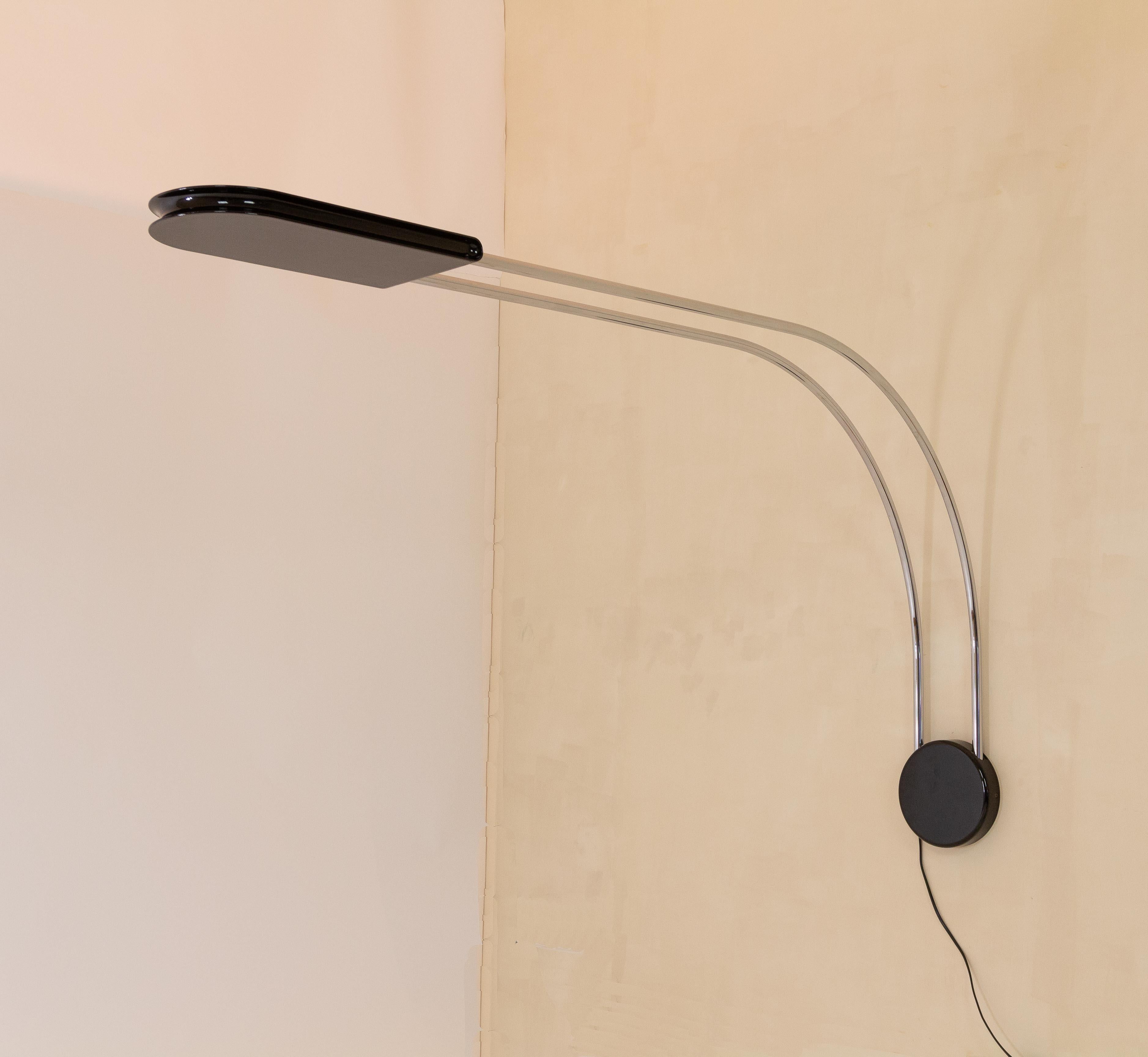 Large Gesto wall lamp by Bruno Gecchelin for Skipper.

After the successful Mezzaluna series Bruno Gecchelin created Gesto in 1975. Initially it was produced as a floor lamp with a halogen bulb, later followed by various wall and ceiling