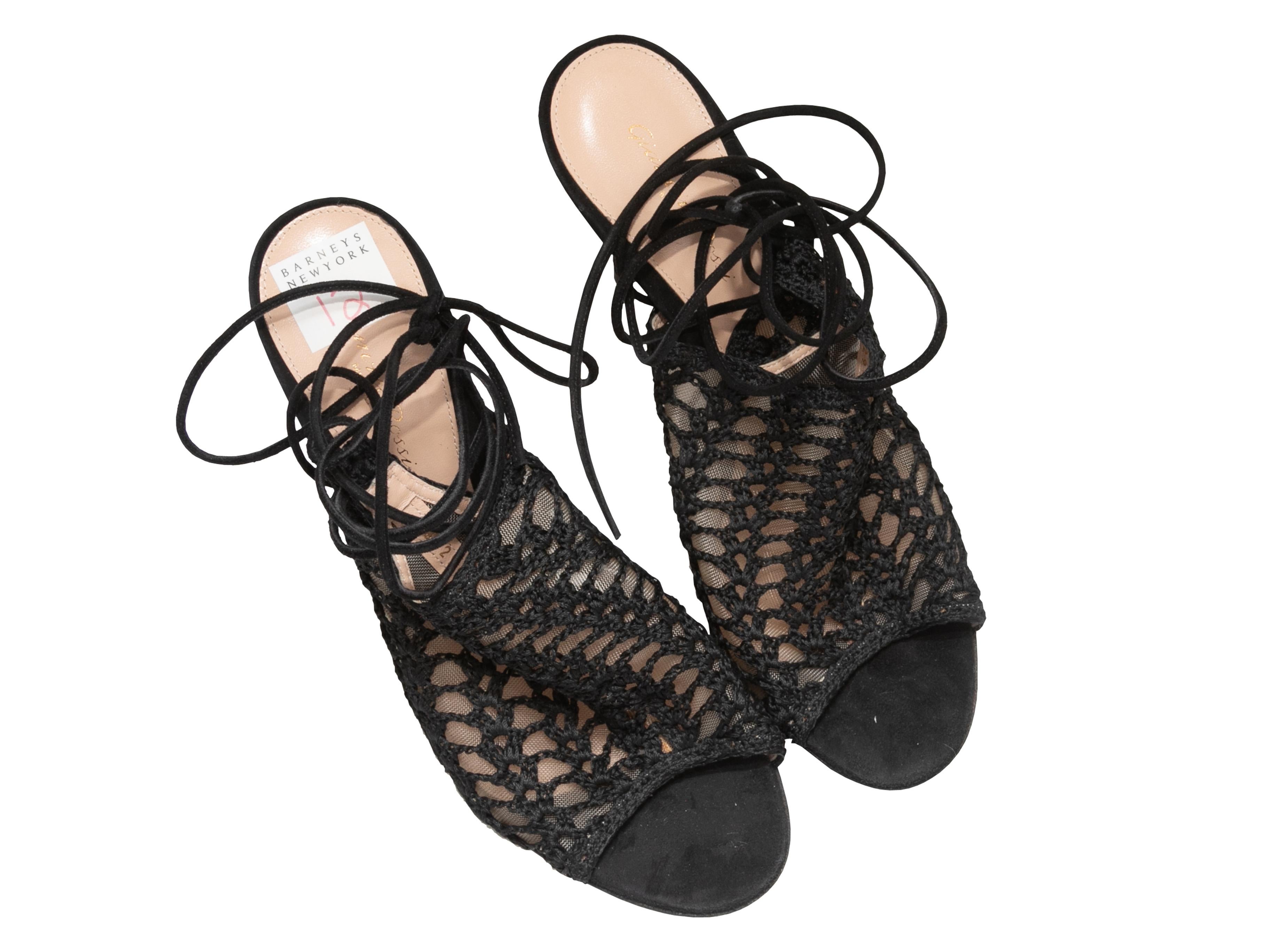 Product Details: Black crochet and mesh lace-up heeled sandals by Gianvito Rossi. Suede trim. Lace-up tie closures at ankles. 4.75