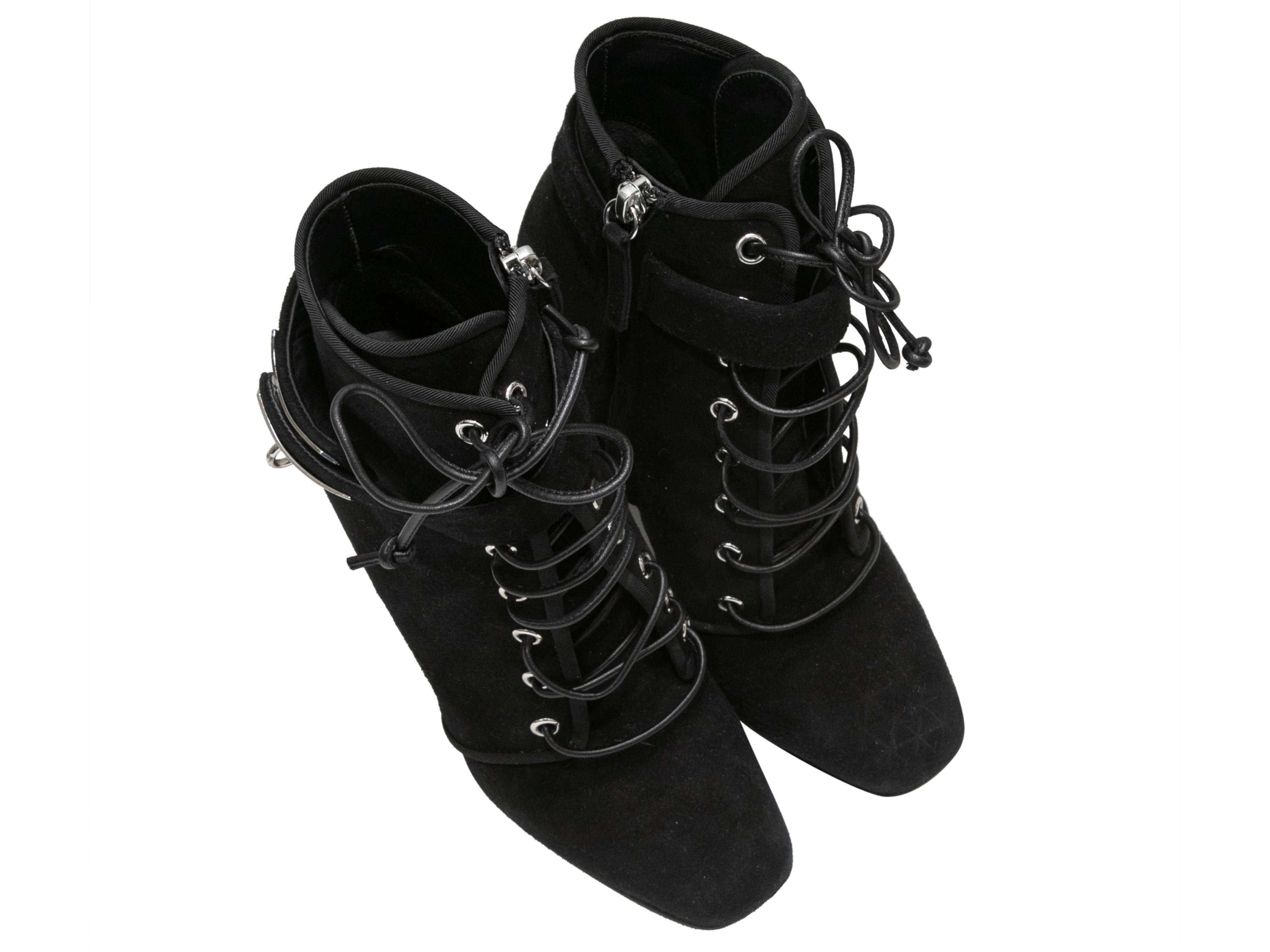 Black suede heeled lace-up ankle boots by Giuseppe Zanotti. Silver-tone turn-lock buckle closures at outer soles. Lace-up detailing at tops. Zip closures at inner sides. 5