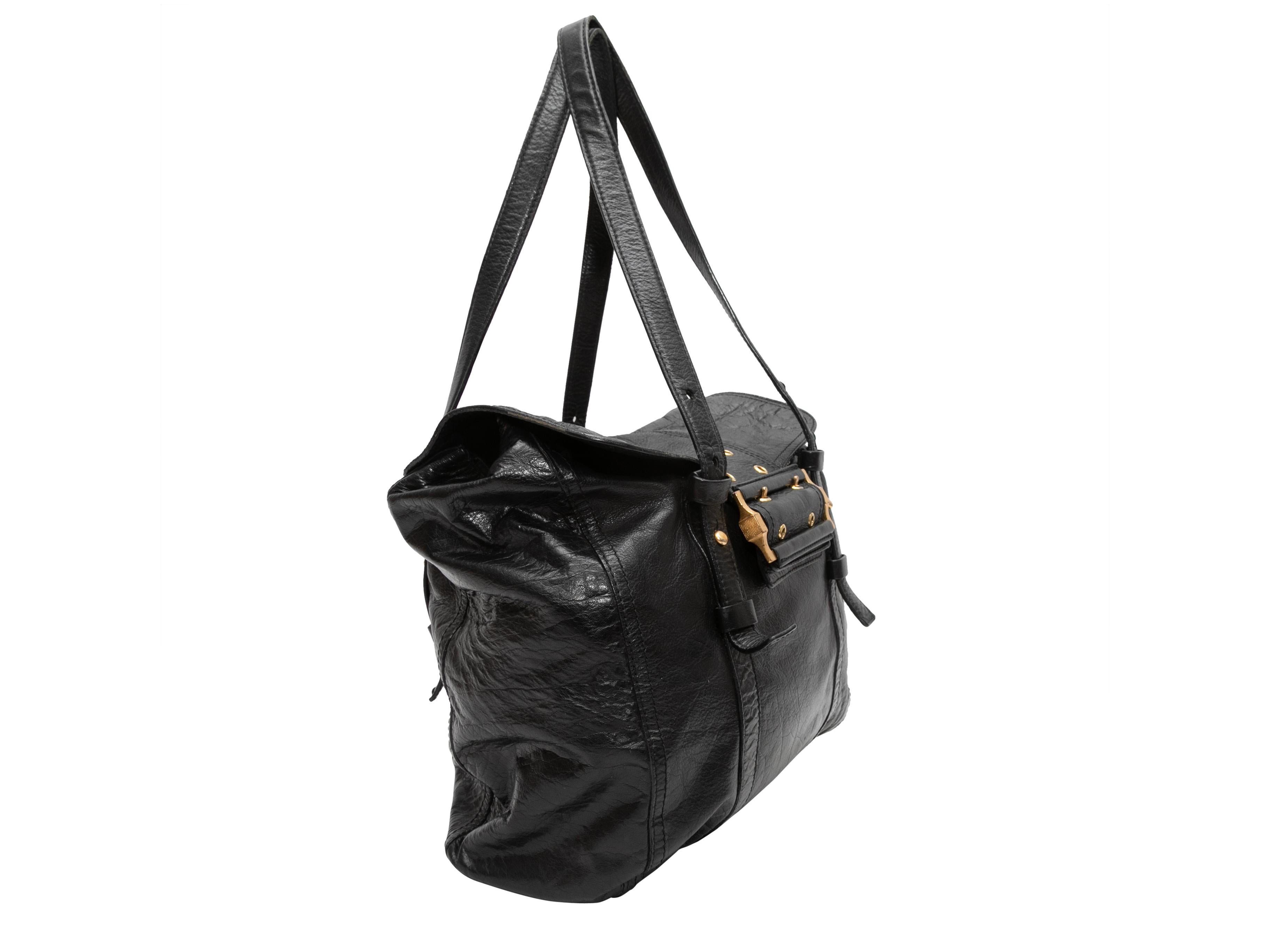 Black Givenchy Large Leather Buckle Tote. This tote bag features a leather body, gold-tone hardware, dual flat adjustable shoulder straps, and a front buckle closure. 15