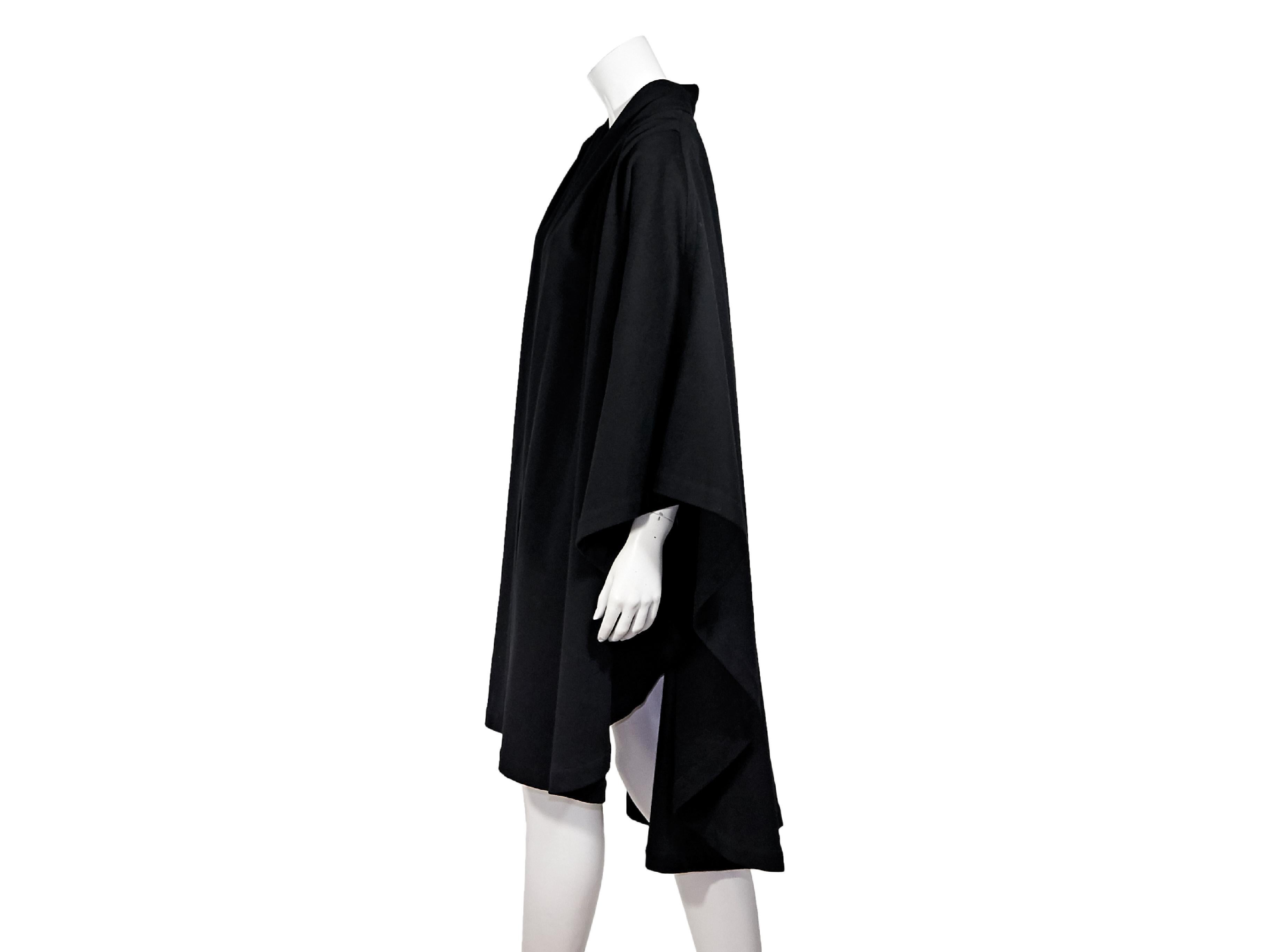Product details:  Black wool cape by Givenchy.  Long sleeves.  Open front.  
Condition: Pre-owned. Very good. 20