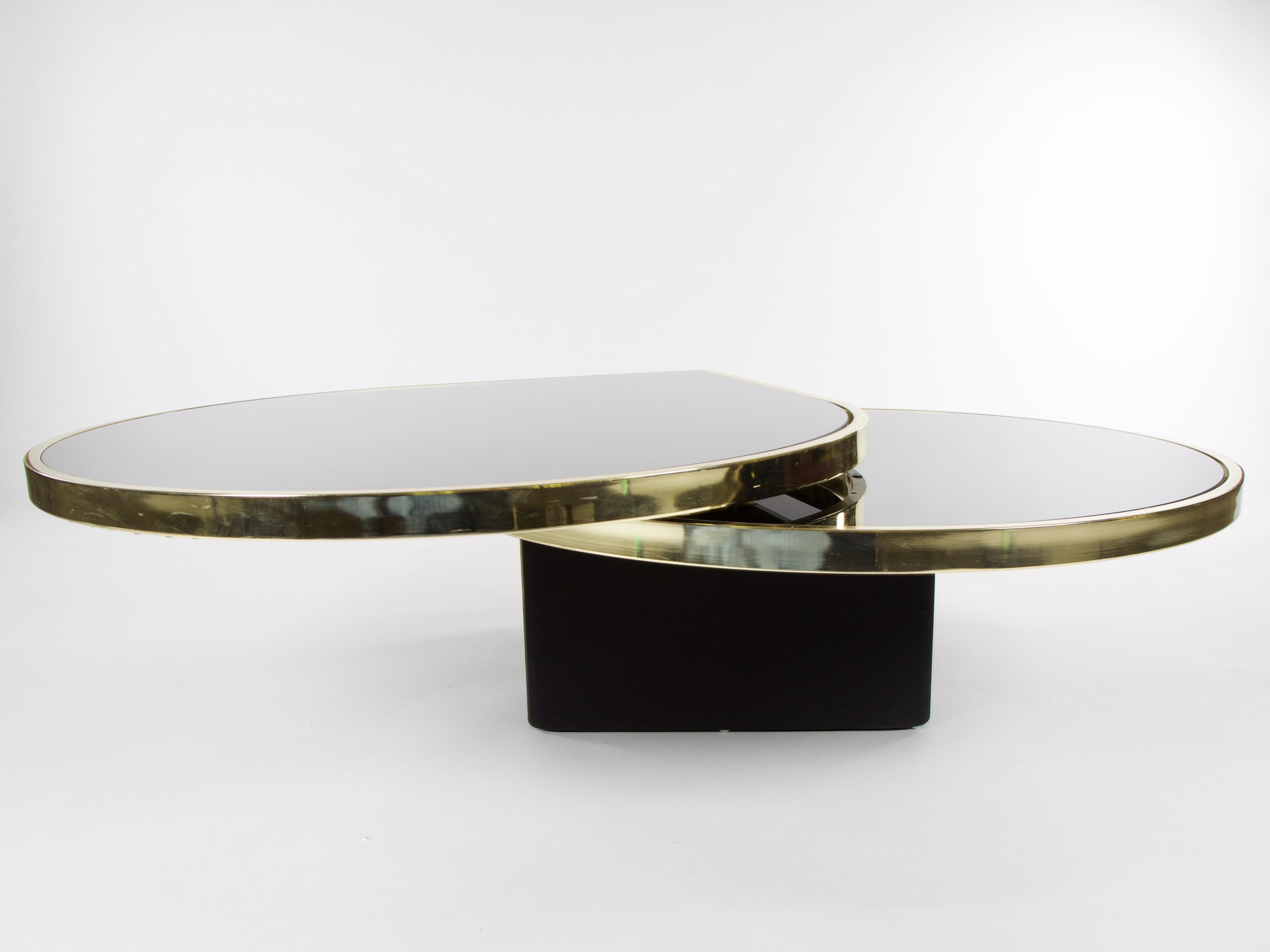 Black glass and brass teardrop swivel cocktail table by DIA, signed
 
Signed (Design Institute American, Inc. 1983, DIA 48447). Attributed to Rougier for The Design Institute of America (DIA) modernist teardrop rotating cocktail table. The table