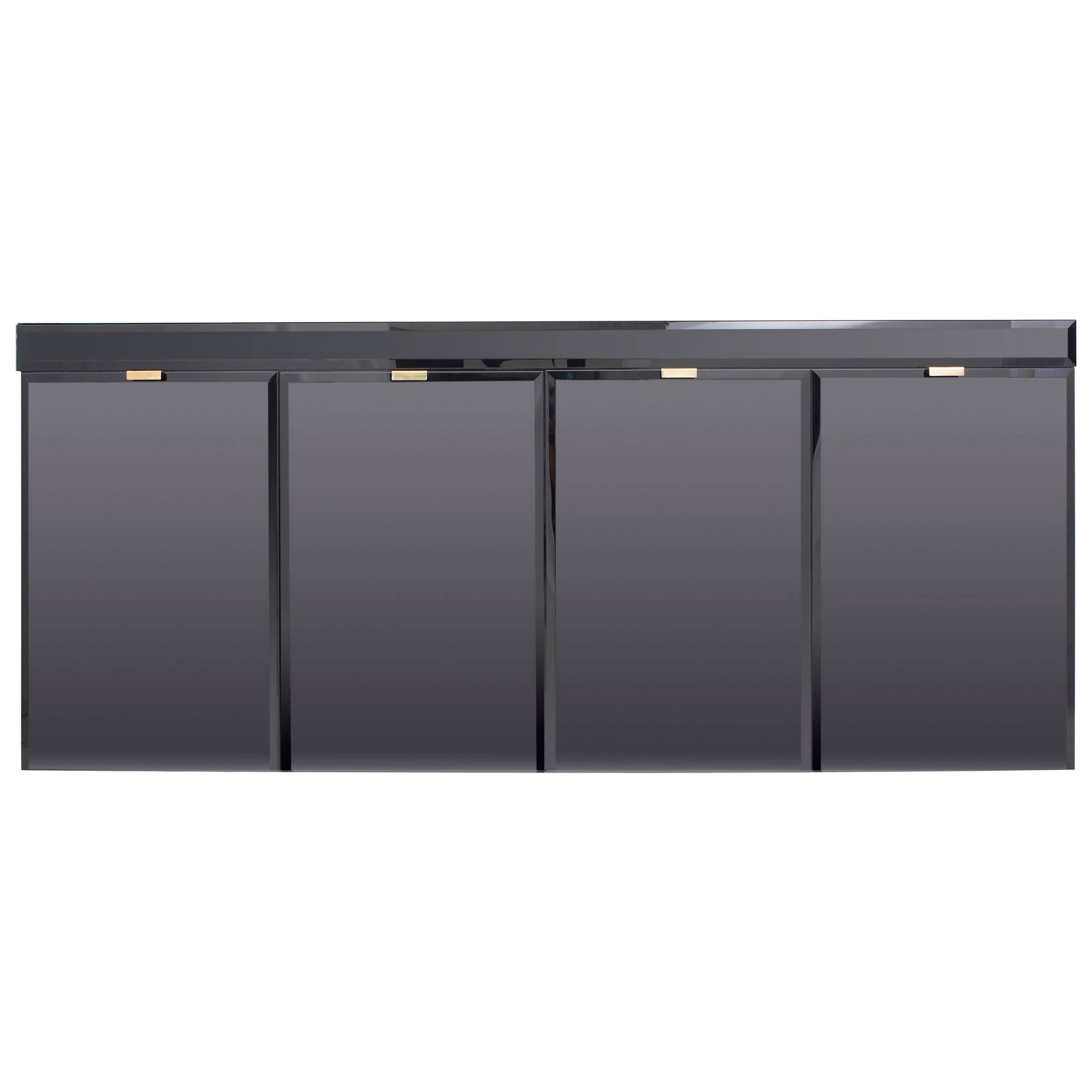 Maison Jansen style Hollywood Regency four-door sideboard.
Amazing detail and quality make this a very elegant piece.

Due to it's slim design it fits almost every space and still provides plenty of storage.

All black hyalite glass all-round