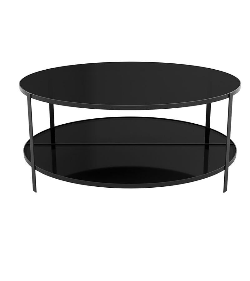 Black glass contemporary coffee table
Dimensions: Diameter 90 x height 37 cm
Materials: Powder-coated iron, tempered glass.
Fumi is an elegant range of coffee tables that looks very light with its black iron frames and tabletops made of glass.
