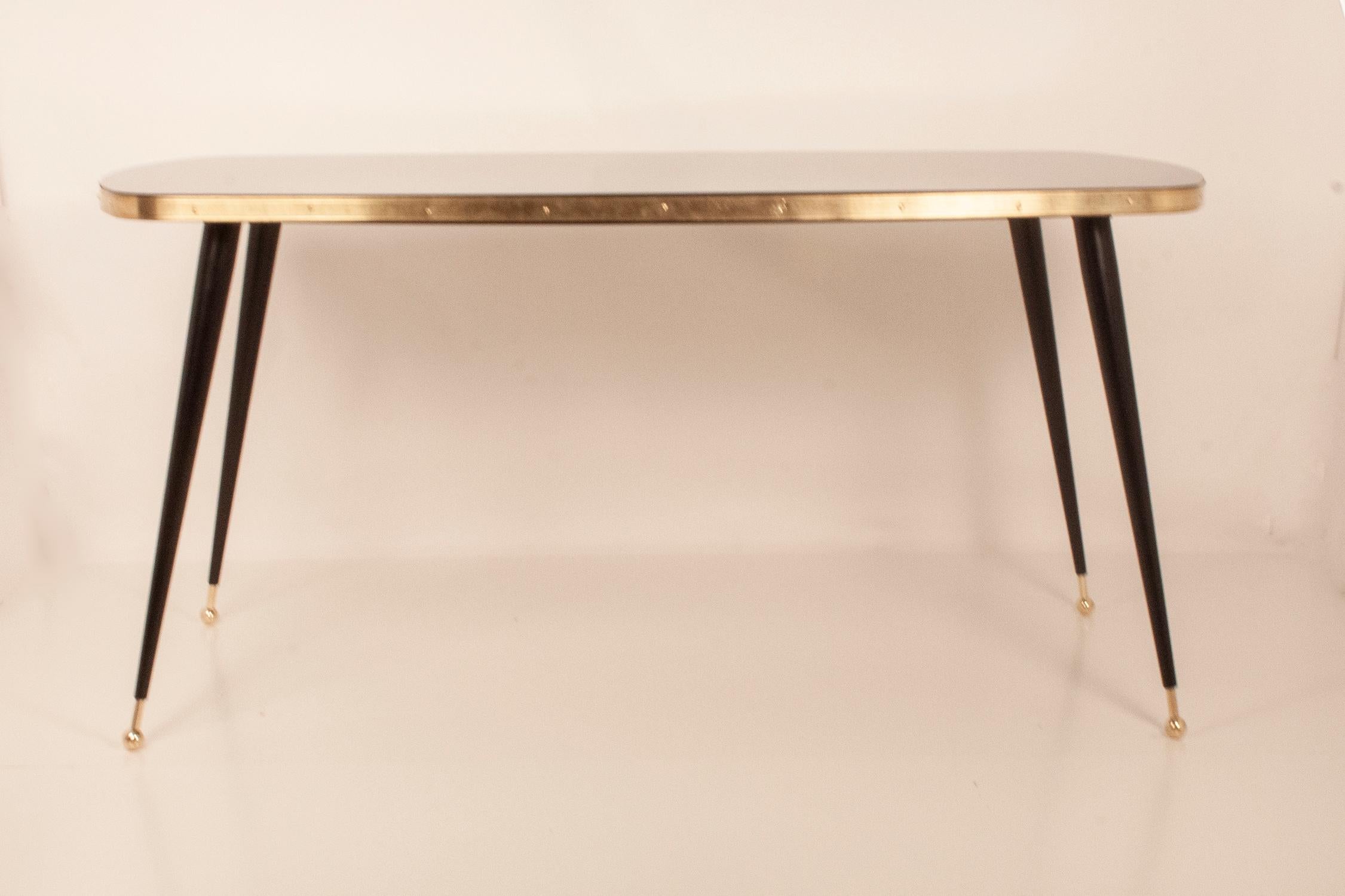 Black glass dining table, brass, black iron legs, Spain. New
Dining table made in DM and with white glass top. The iron legs are lacquered in black. Golden brass leg termination.
It can be done in different; shapes (round, square, oval ....) back