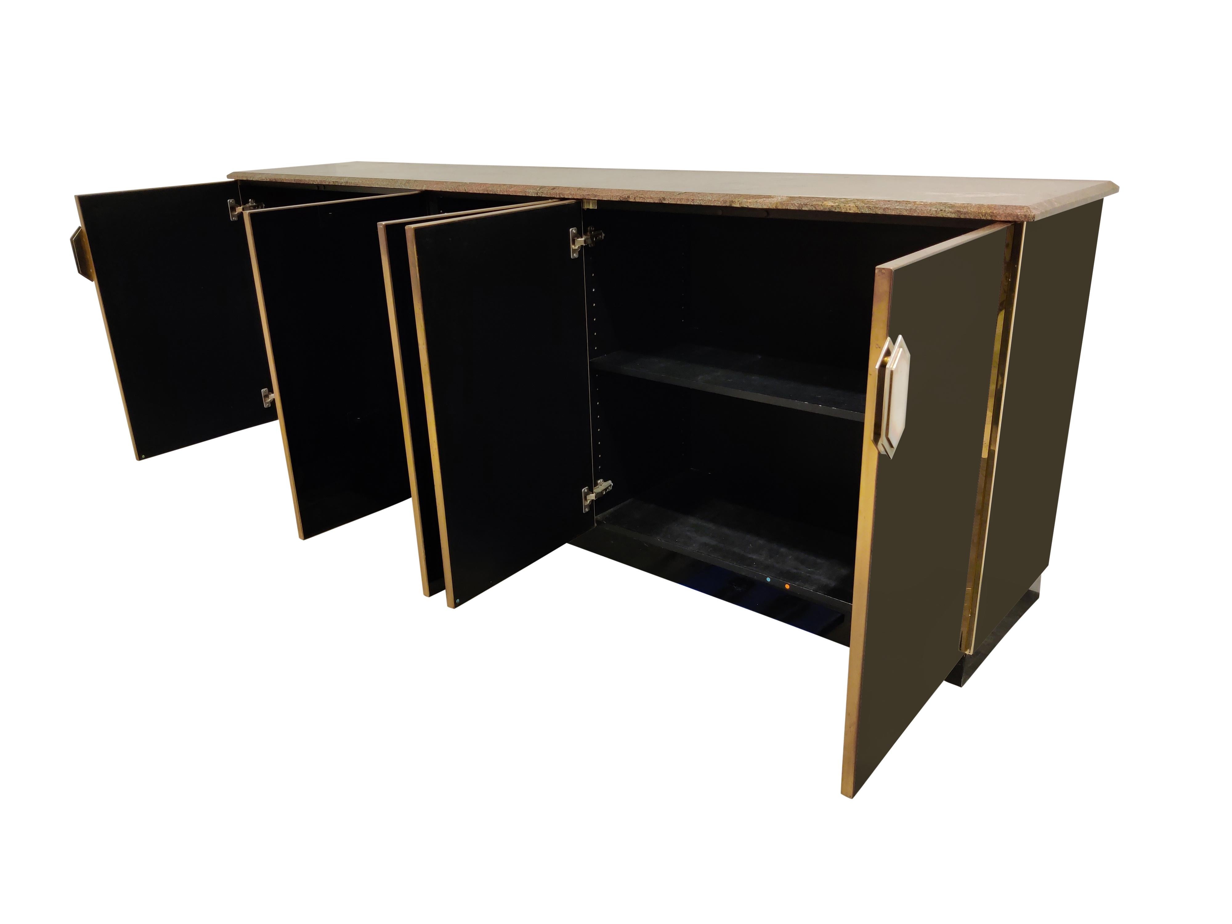 Hollywood Regency black glass and brass credenza with a beautiful granite stone top.

It features 5 doors with unique handles. 

This pieces gives a great touch of 1970s/1980s glamour to your room.

1970s - France

Good condition with normal