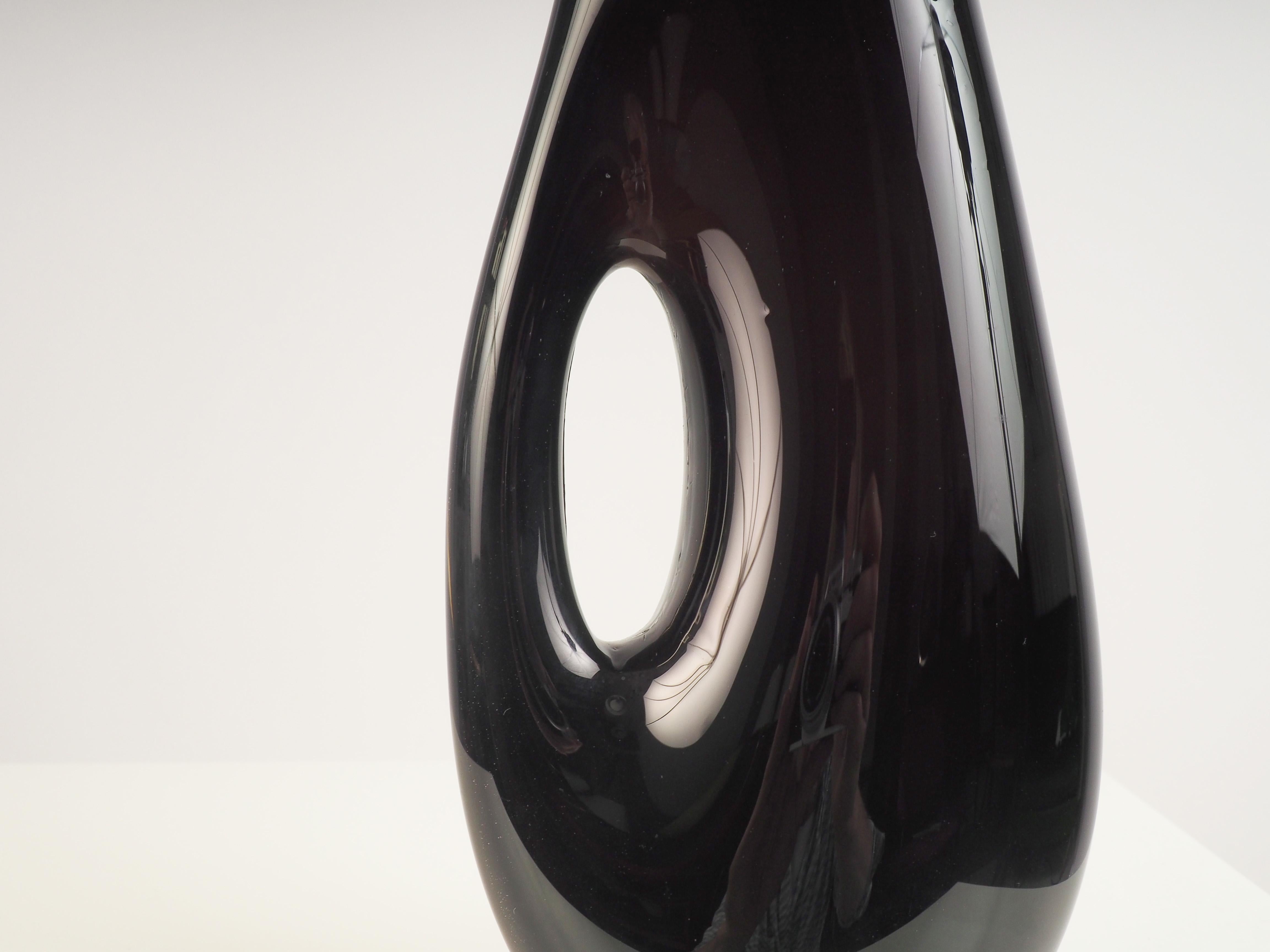 black vase with hole in middle